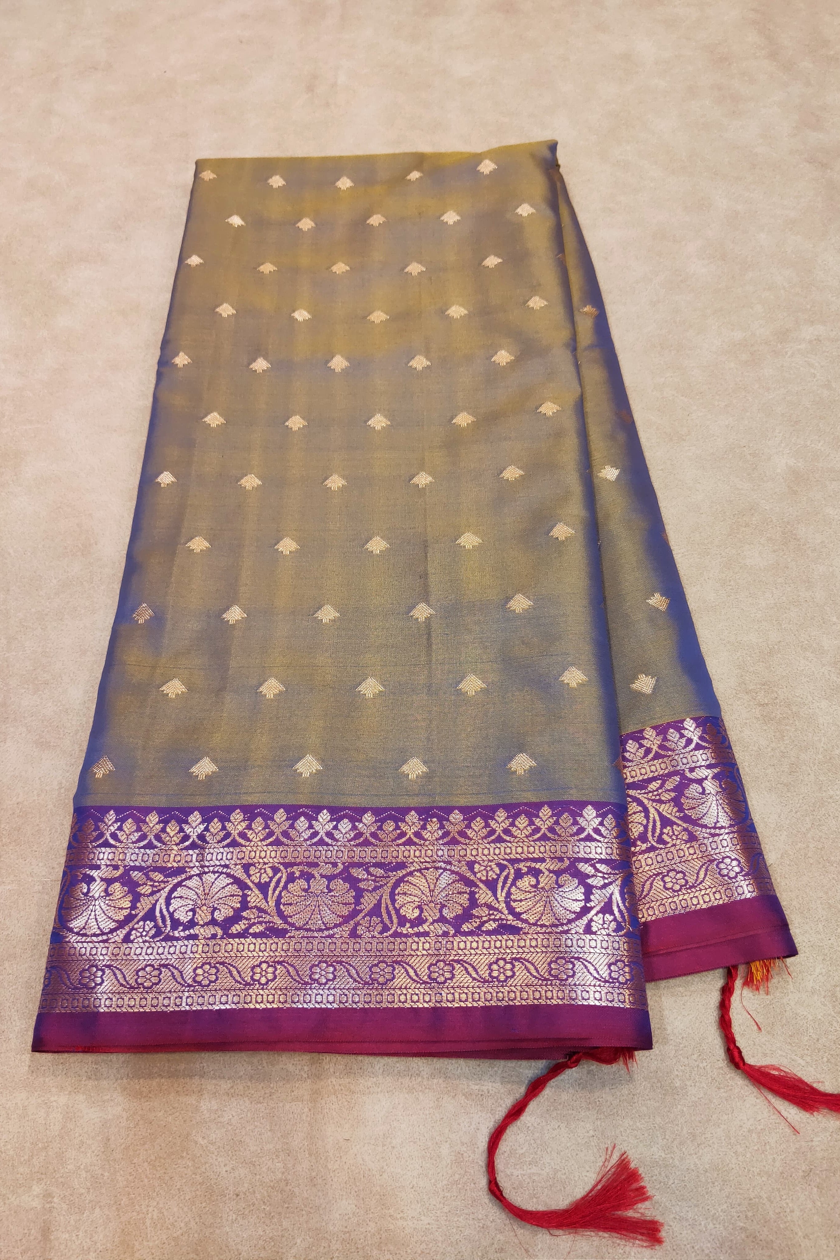 Traditional saree with a purple border on a beige background