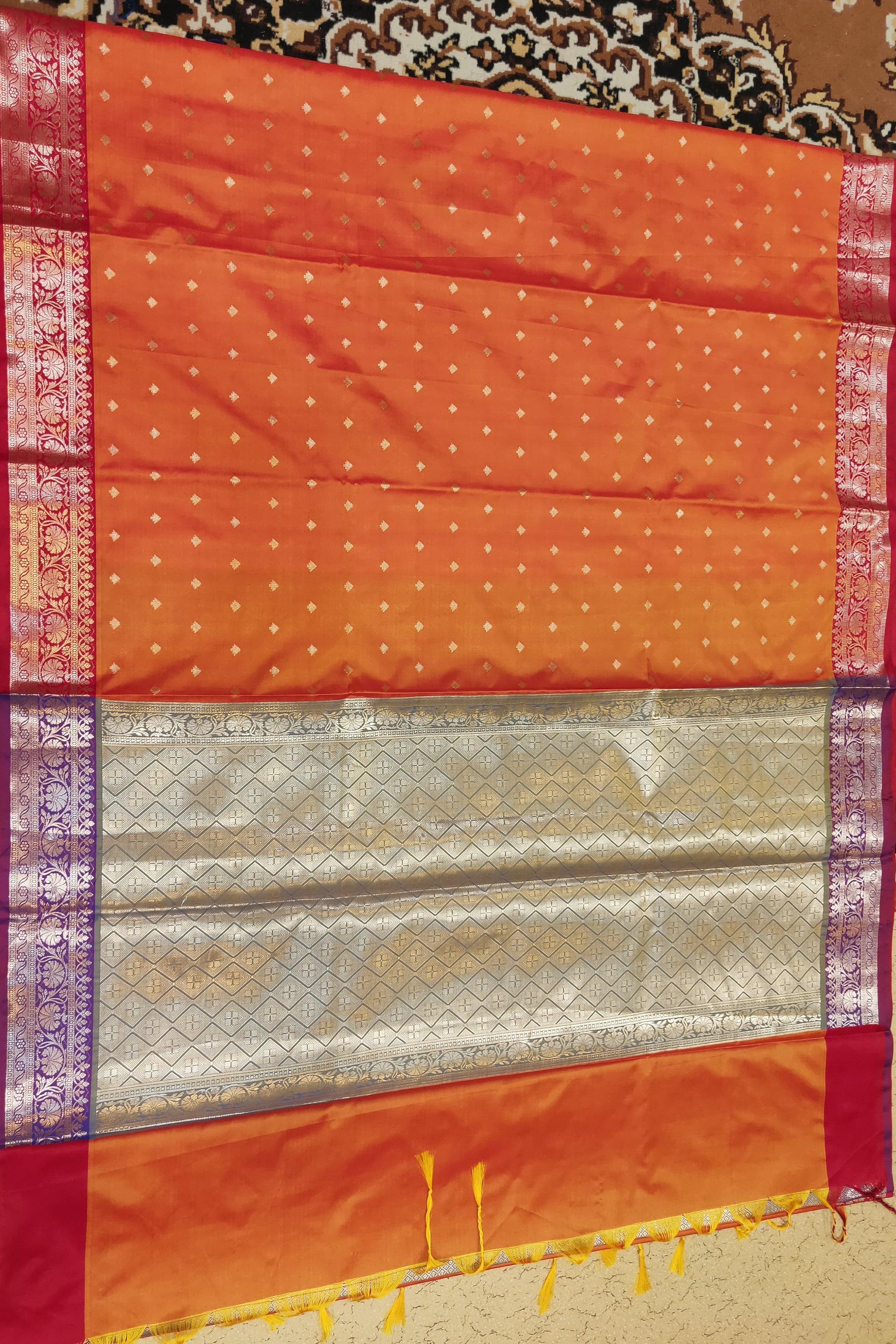Orange fabric with intricate patterns on a patterned background
