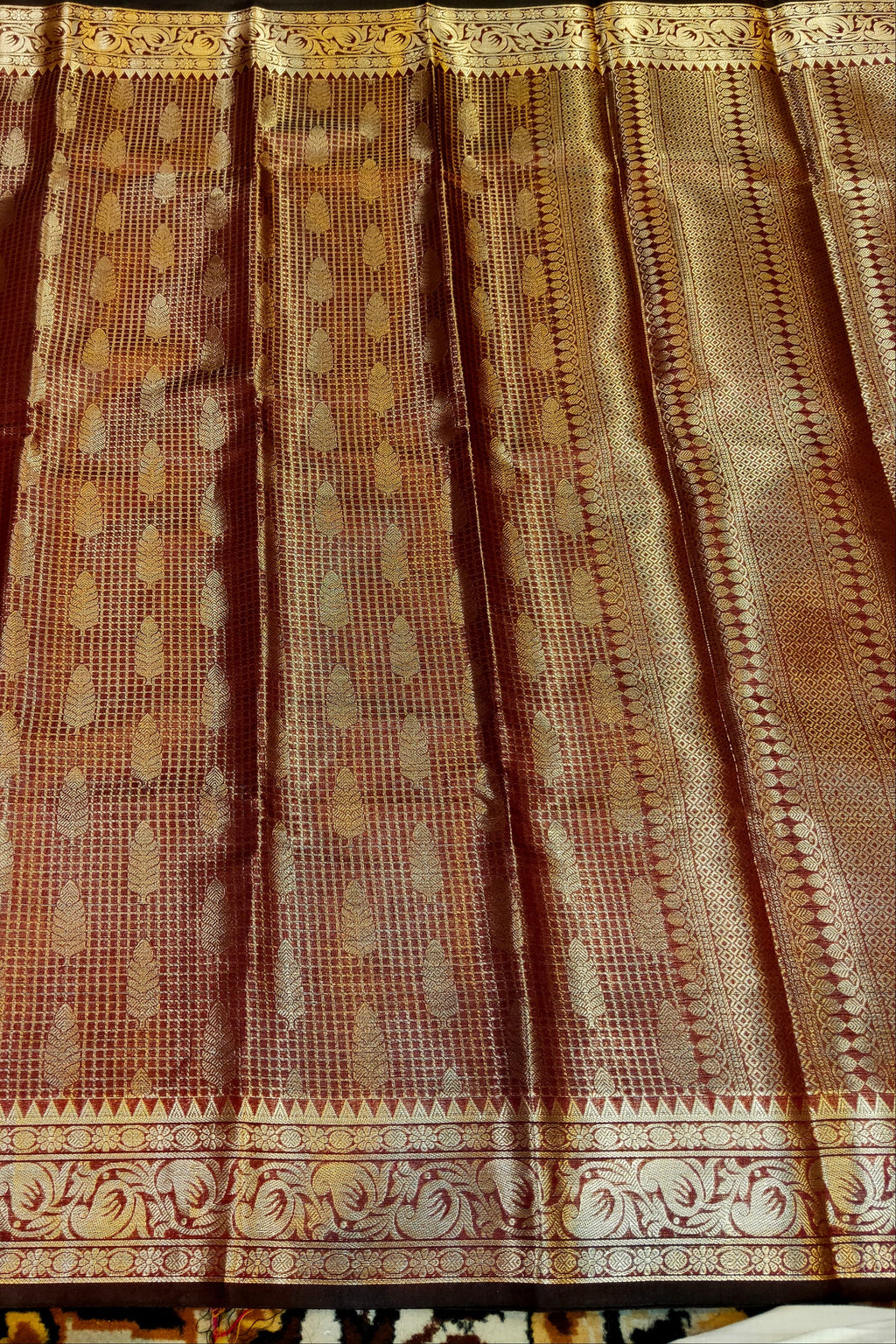 Textured fabric with intricate patterns and colors, possibly a curtain or a piece of clothing.