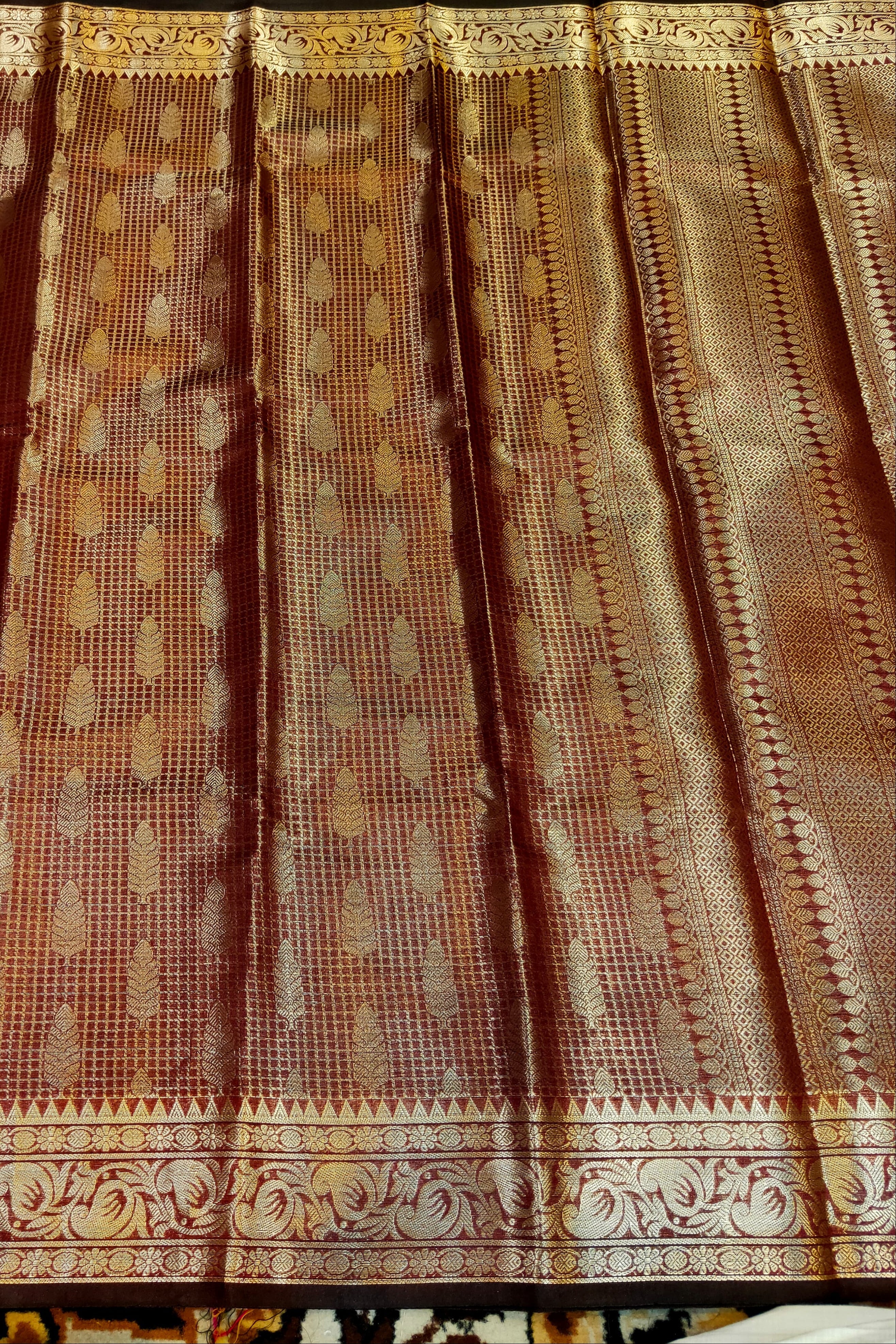 Textured fabric with intricate patterns and colors, possibly a curtain or a piece of clothing.