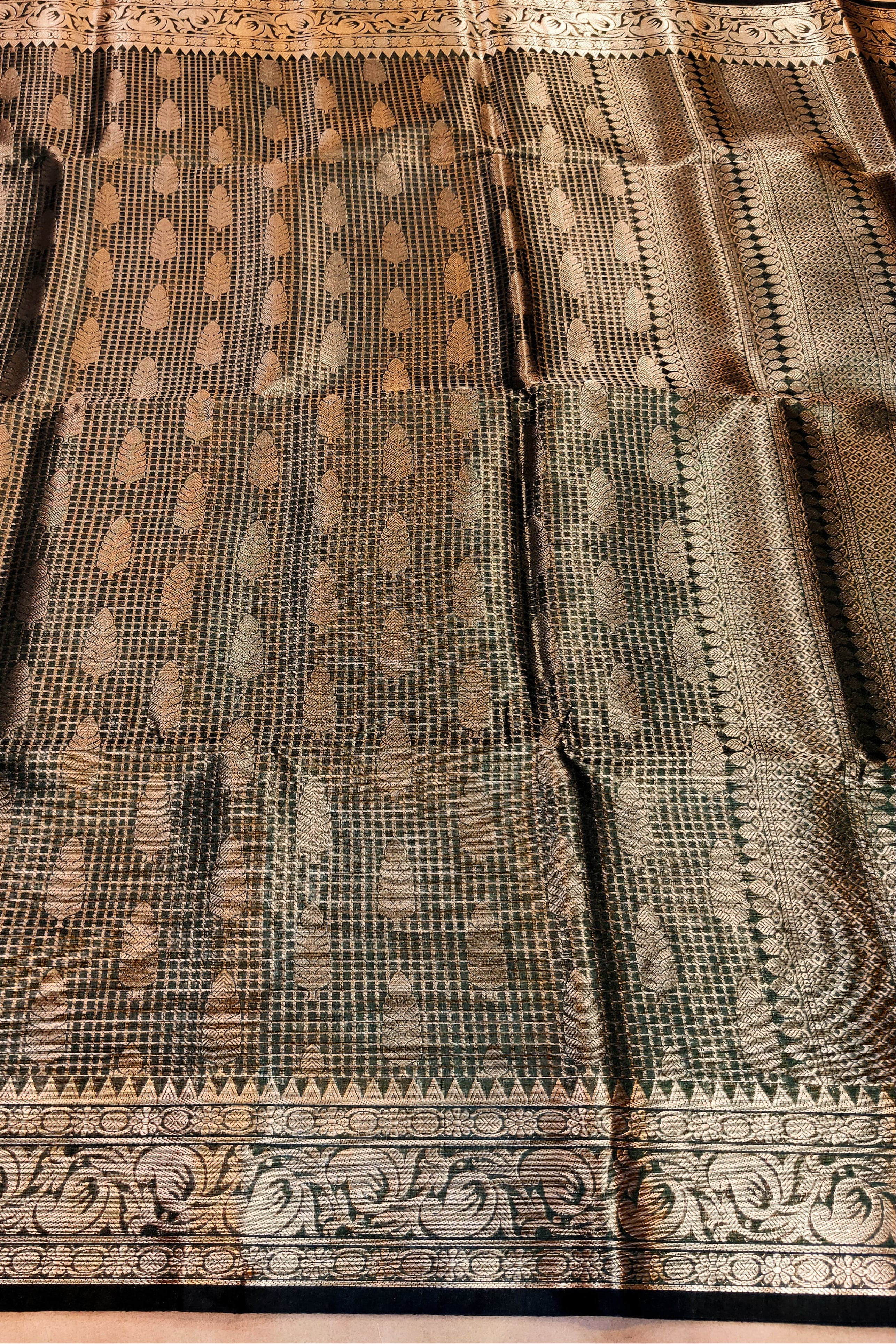 Traditional saree with intricate patterns on a wooden surface