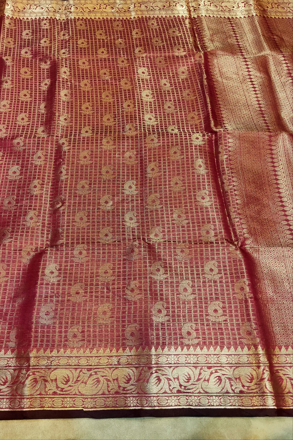 Red and gold patterned fabric with intricate design