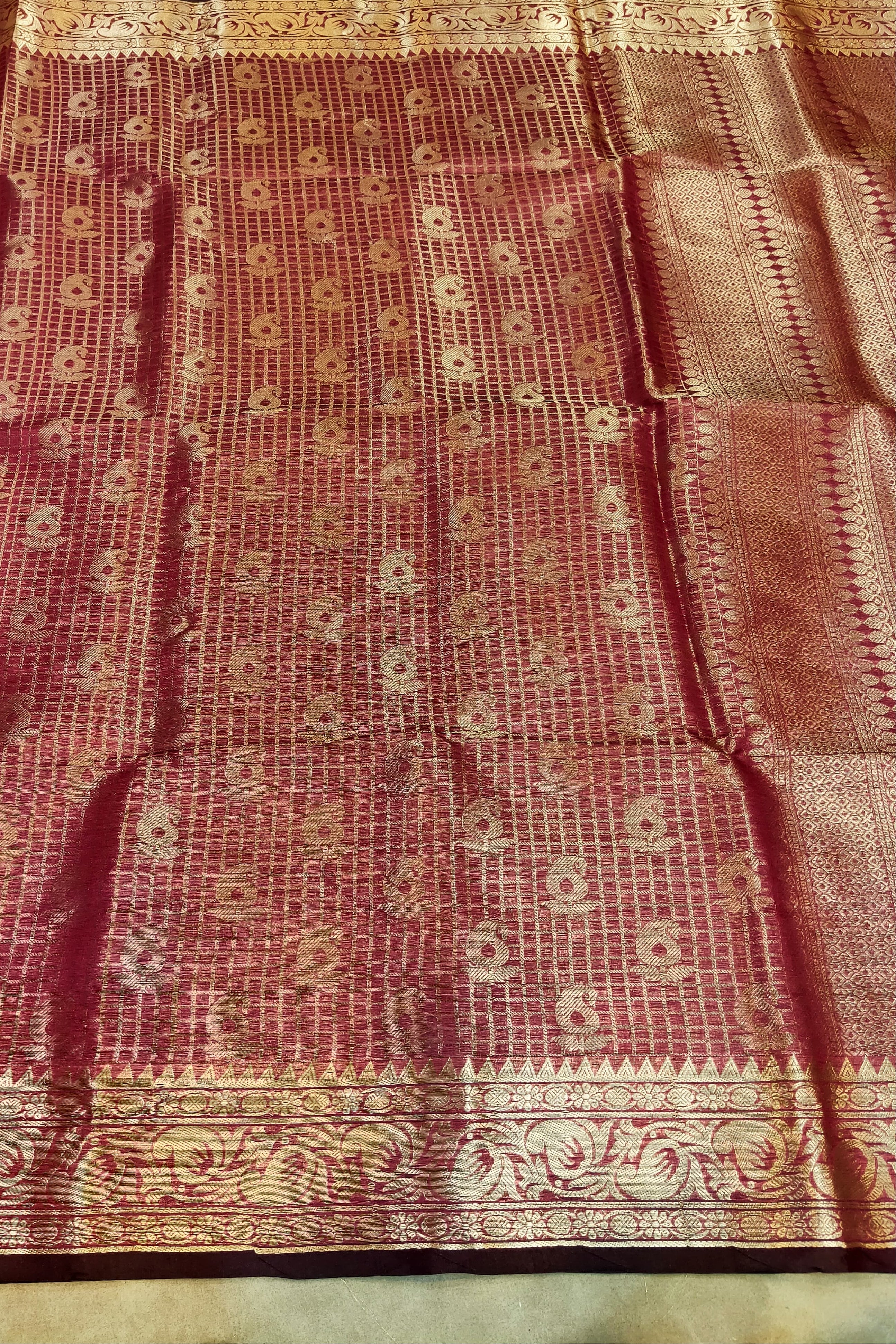 Red and gold patterned fabric with intricate design