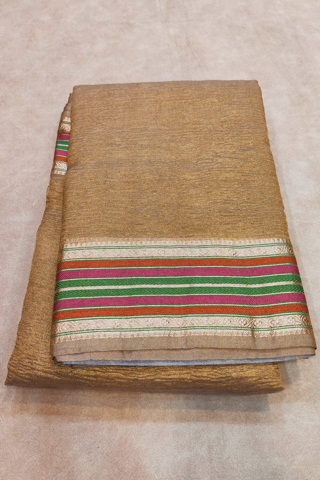 gold saree on a flat surface