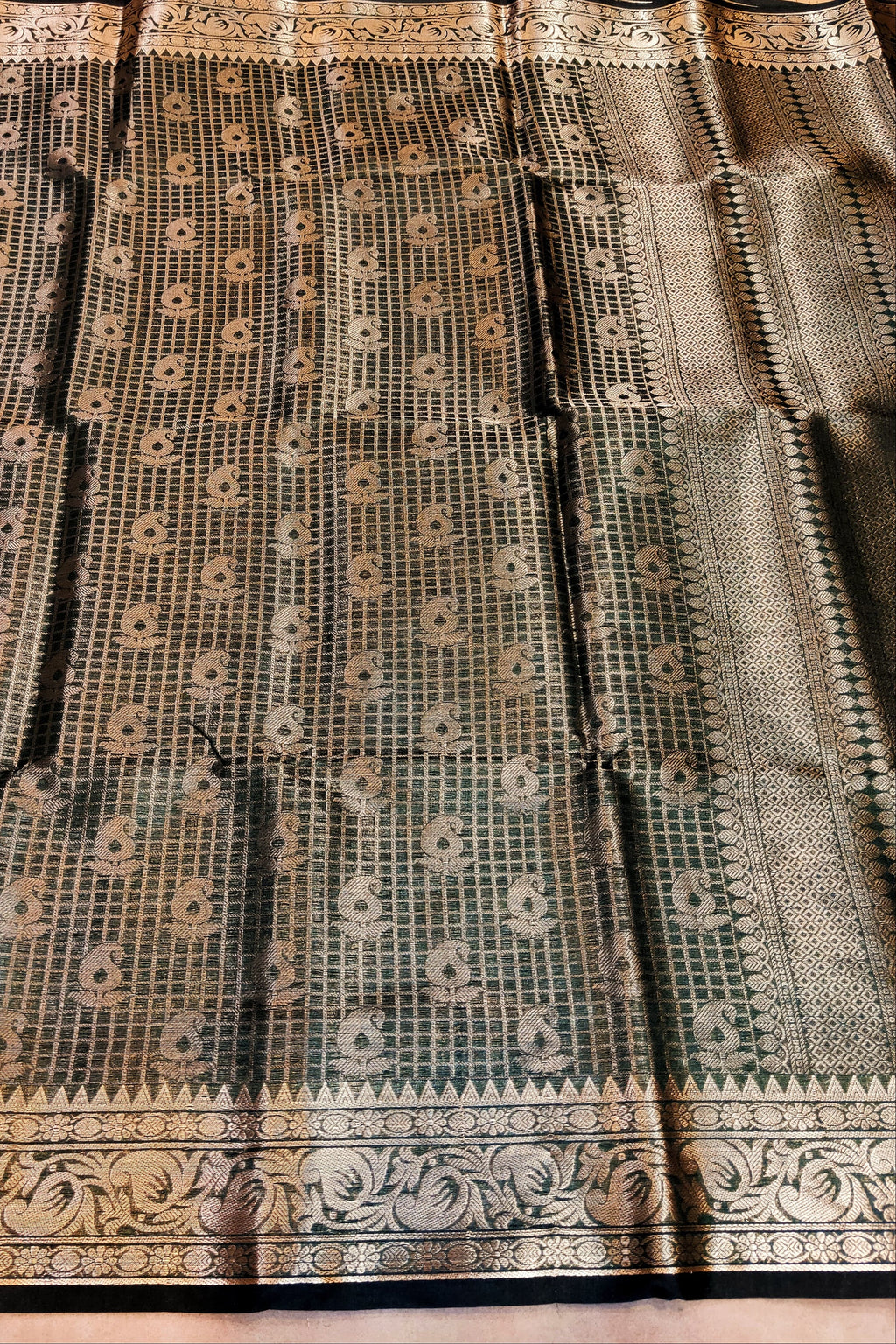 Black and white patterned fabric with intricate designs on a wooden surface