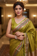 woman in yellow saree indoors