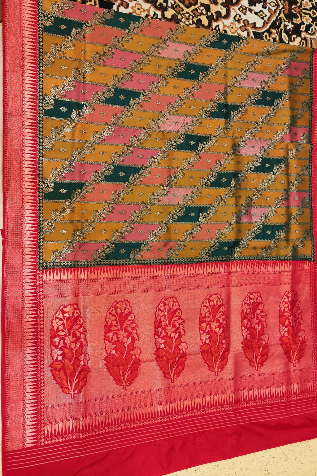 Saree with a geometric pattern and floral border on a plain background