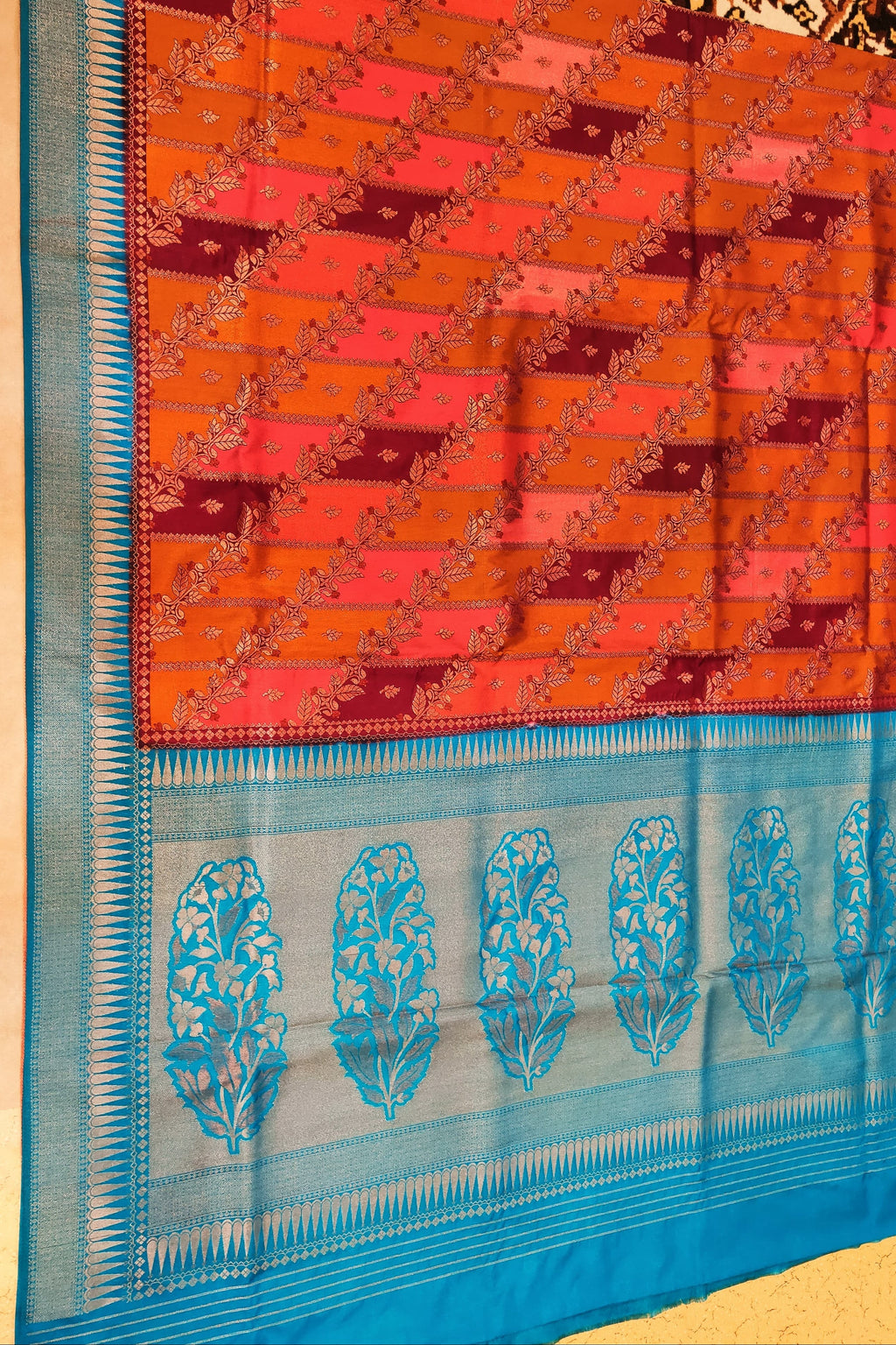 Saree with orange and red checkered pattern and blue border