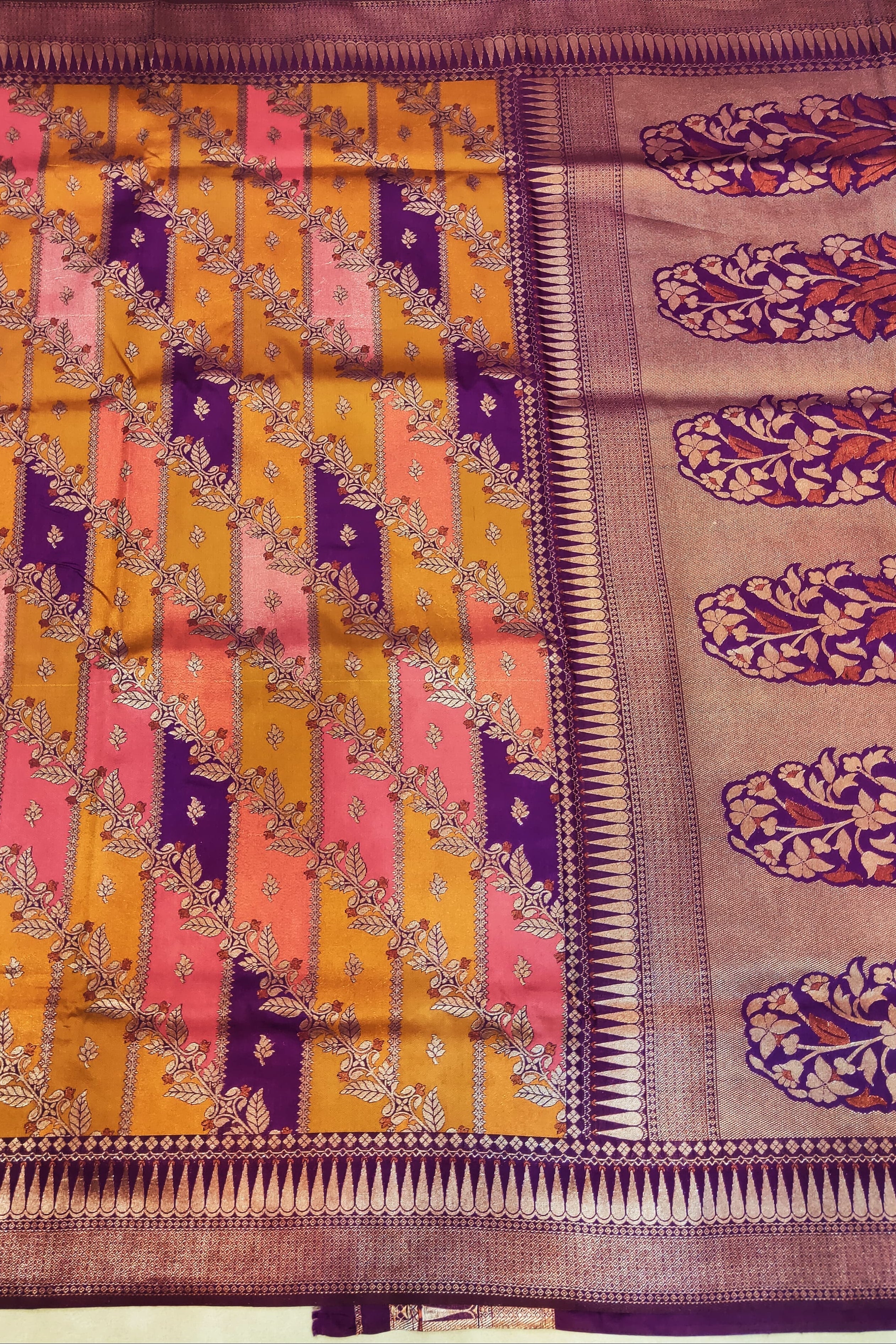 Colorful saree with intricate patterns on a plain background