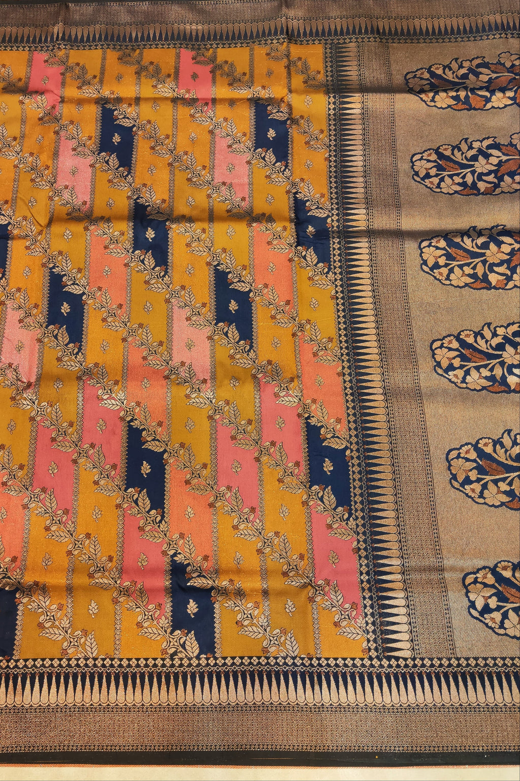 Traditional saree with intricate patterns and colors on a plain background