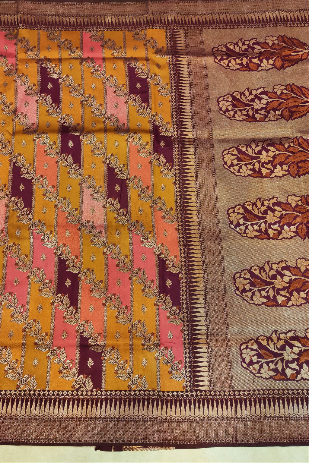 Traditional saree with a patterned design on a plain background