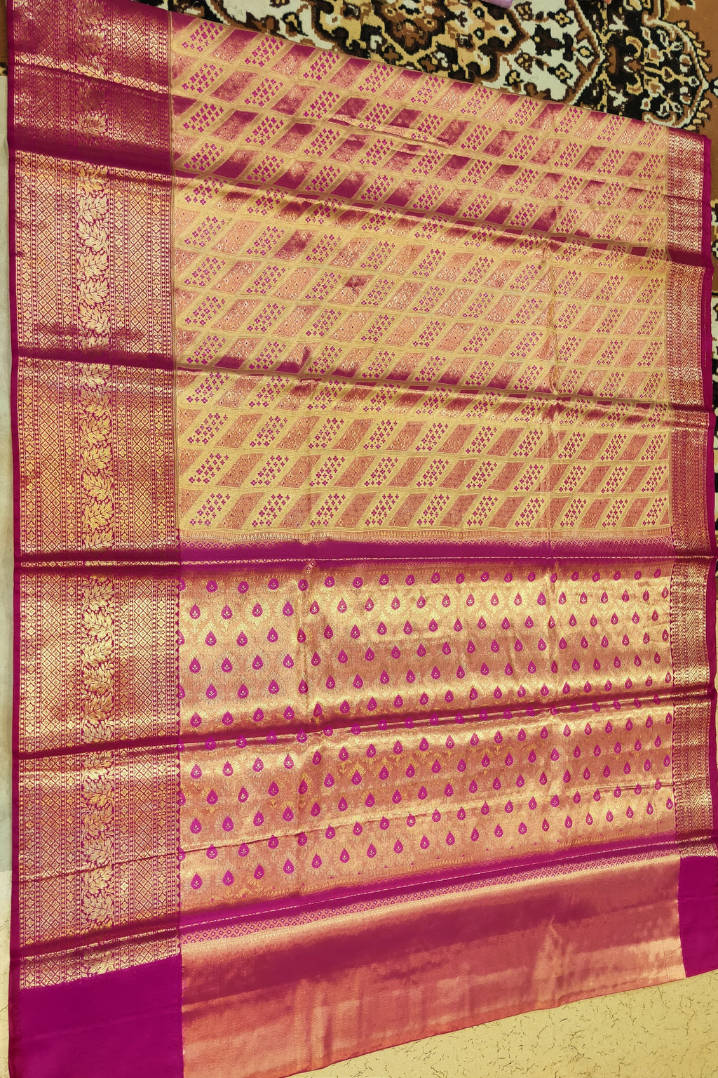 Traditional patterned fabric with a prominent border on a plain background