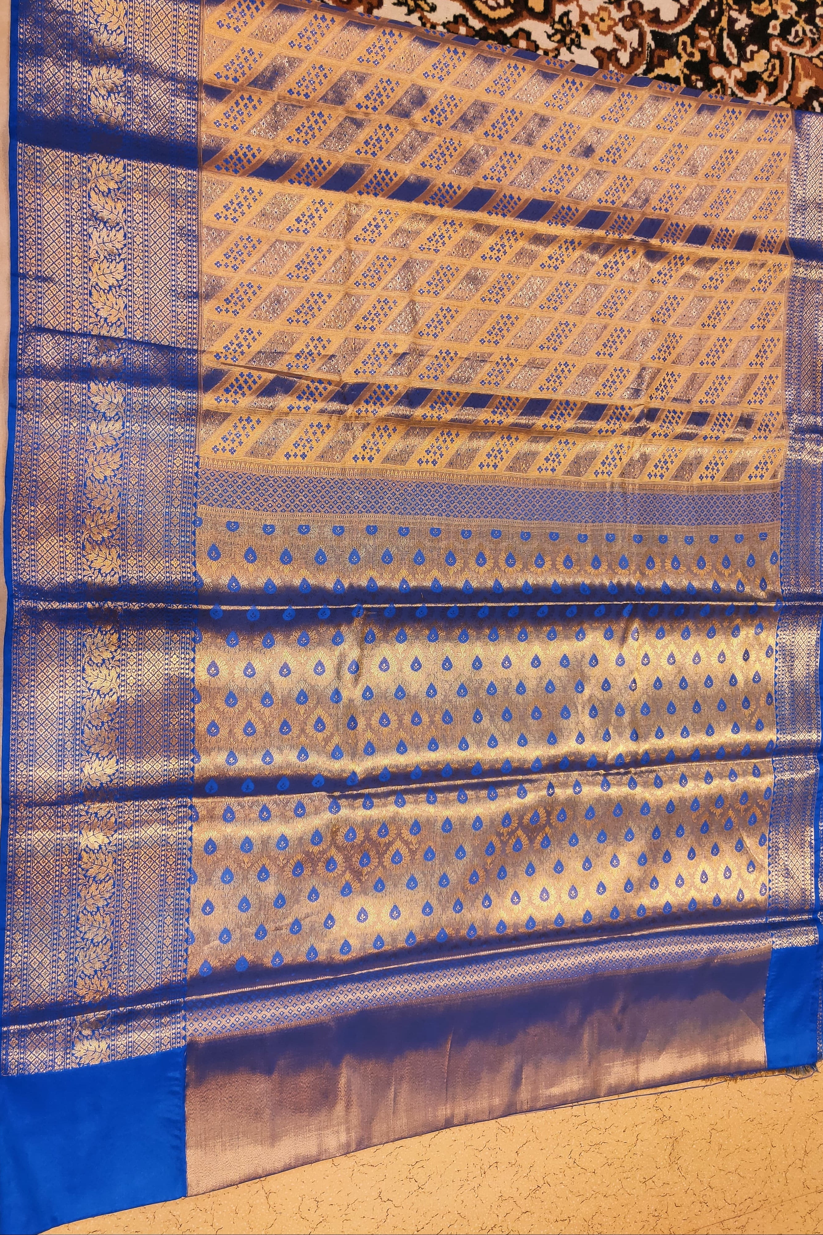 Blue and beige patterned fabric on a plain background