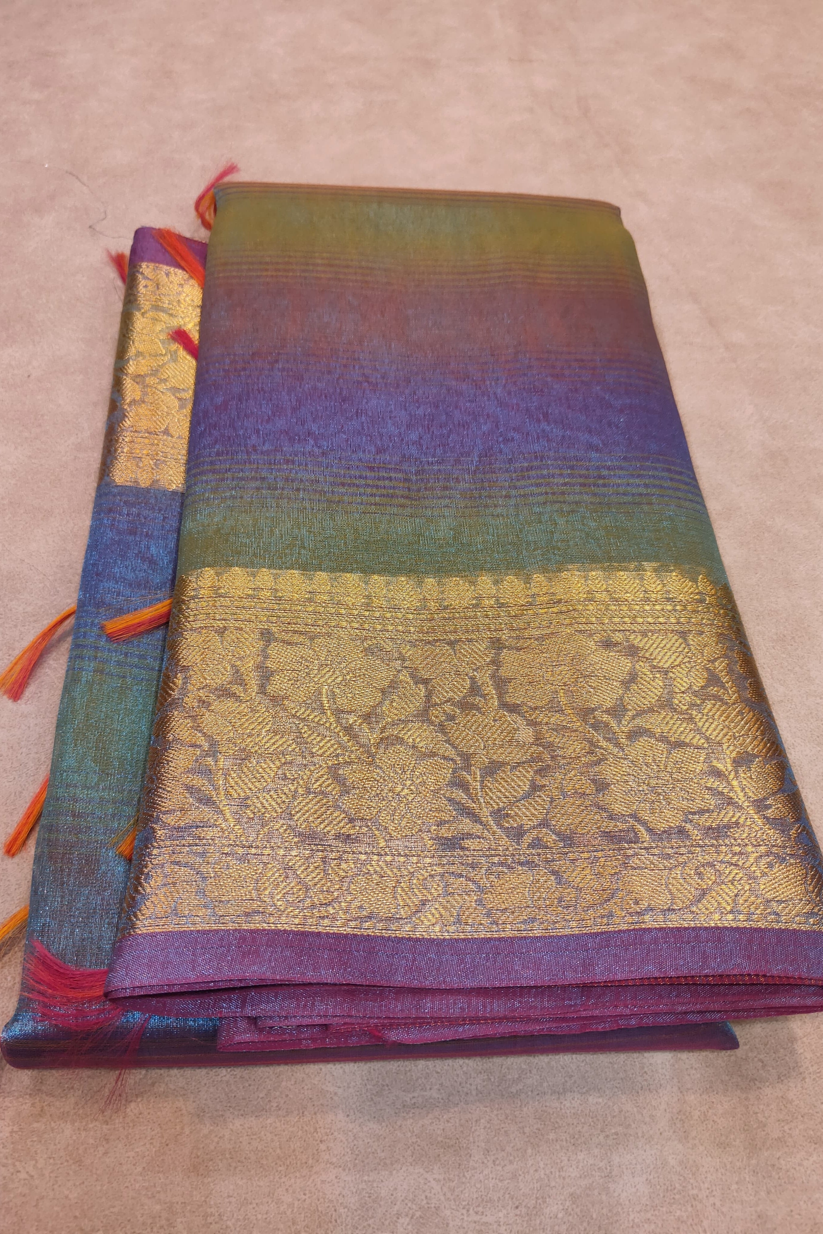 Folded fabric with colorful patterns on a beige surface