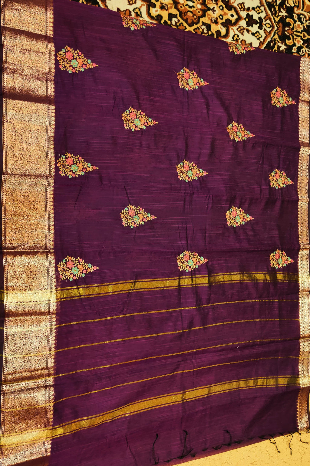 Purple fabric with floral patterns on a textured background