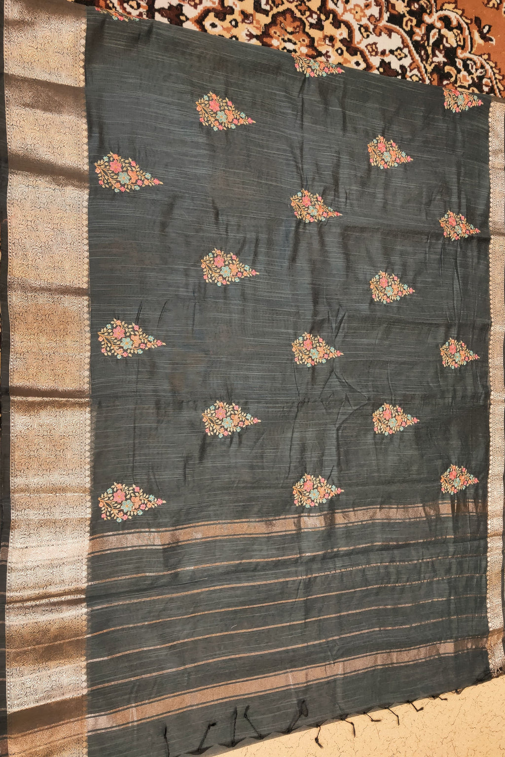 Dark fabric with floral patterns on a textured surface