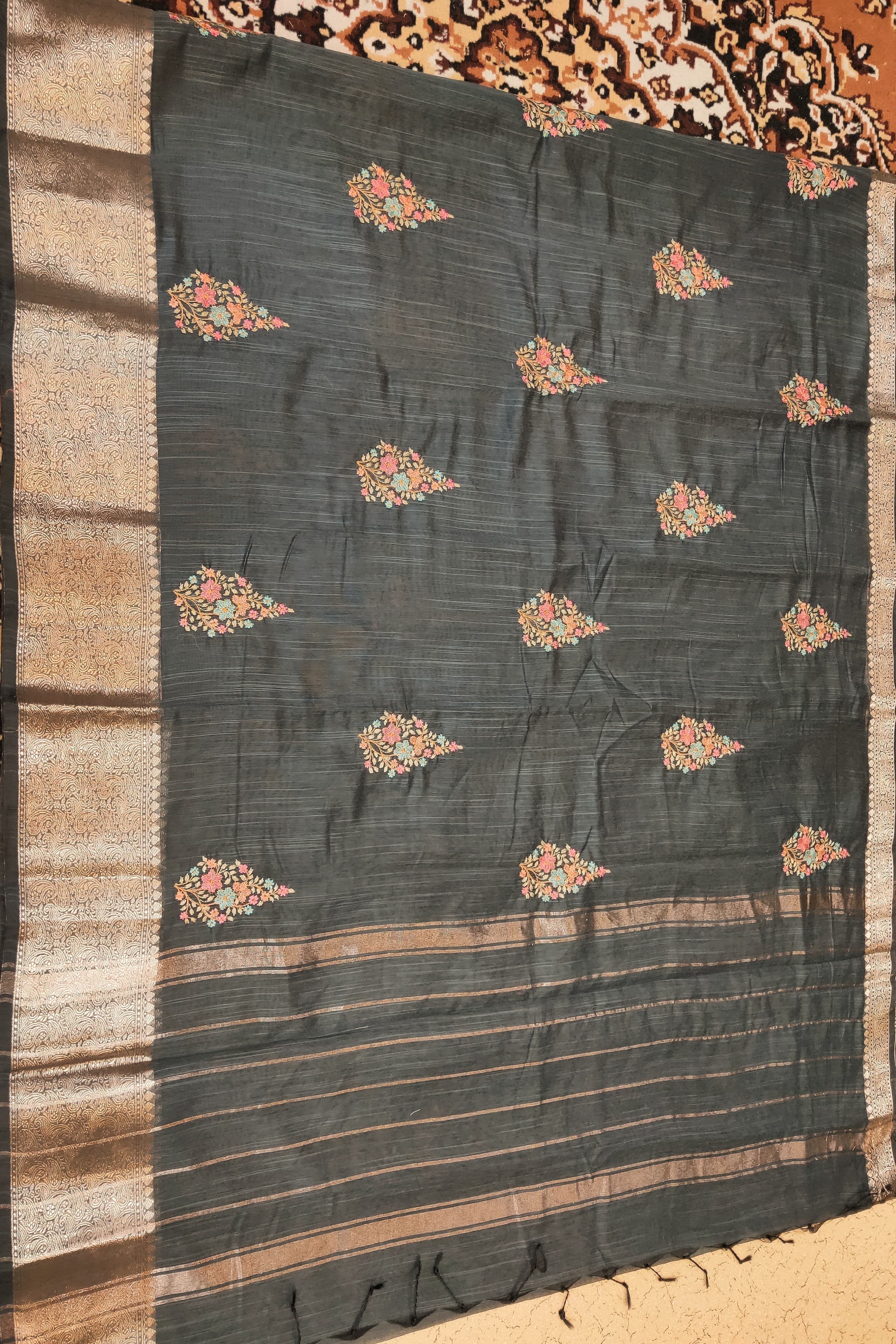Dark fabric with floral patterns on a textured surface