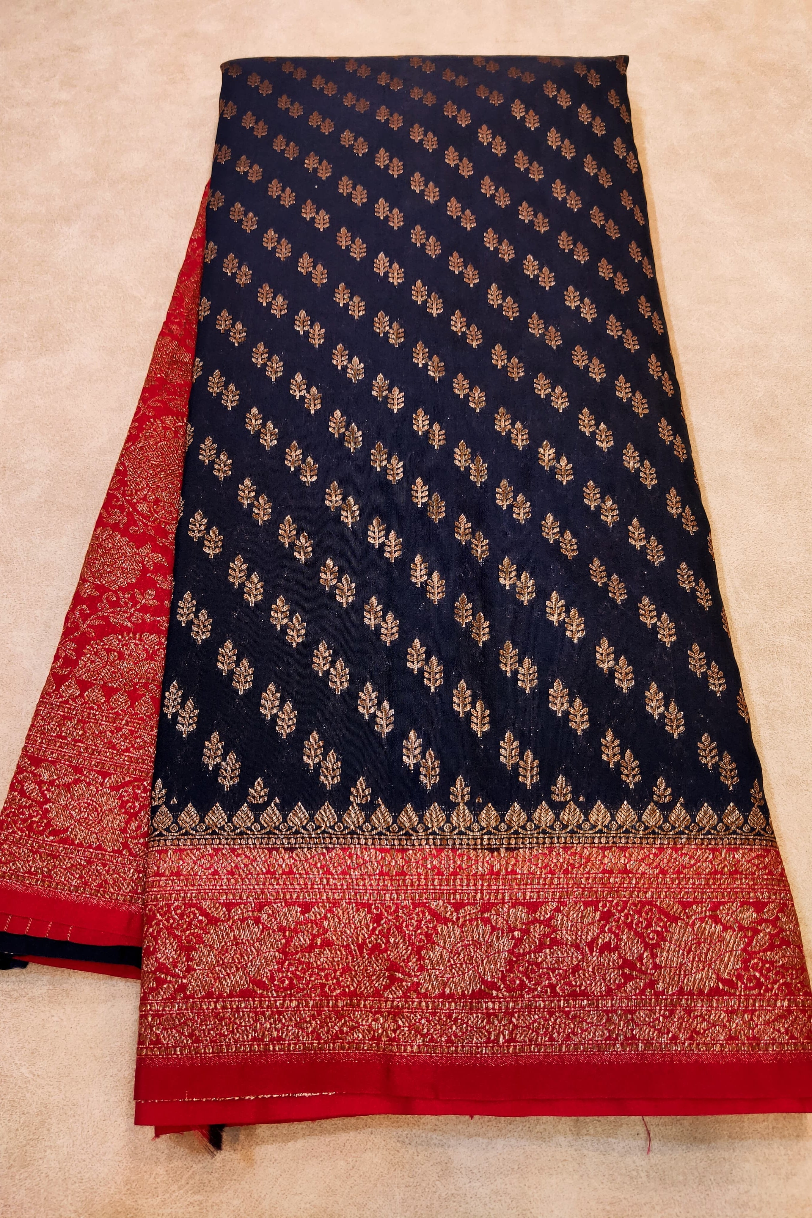 Navy blue and red patterned fabric on a beige background