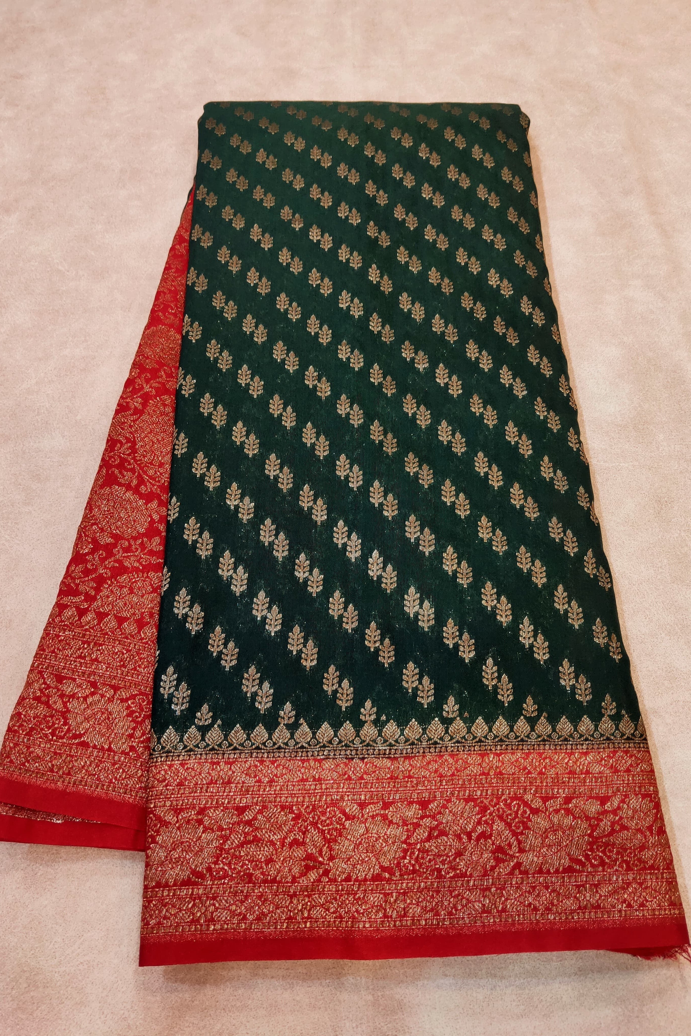 Green and red patterned fabric on a beige background
