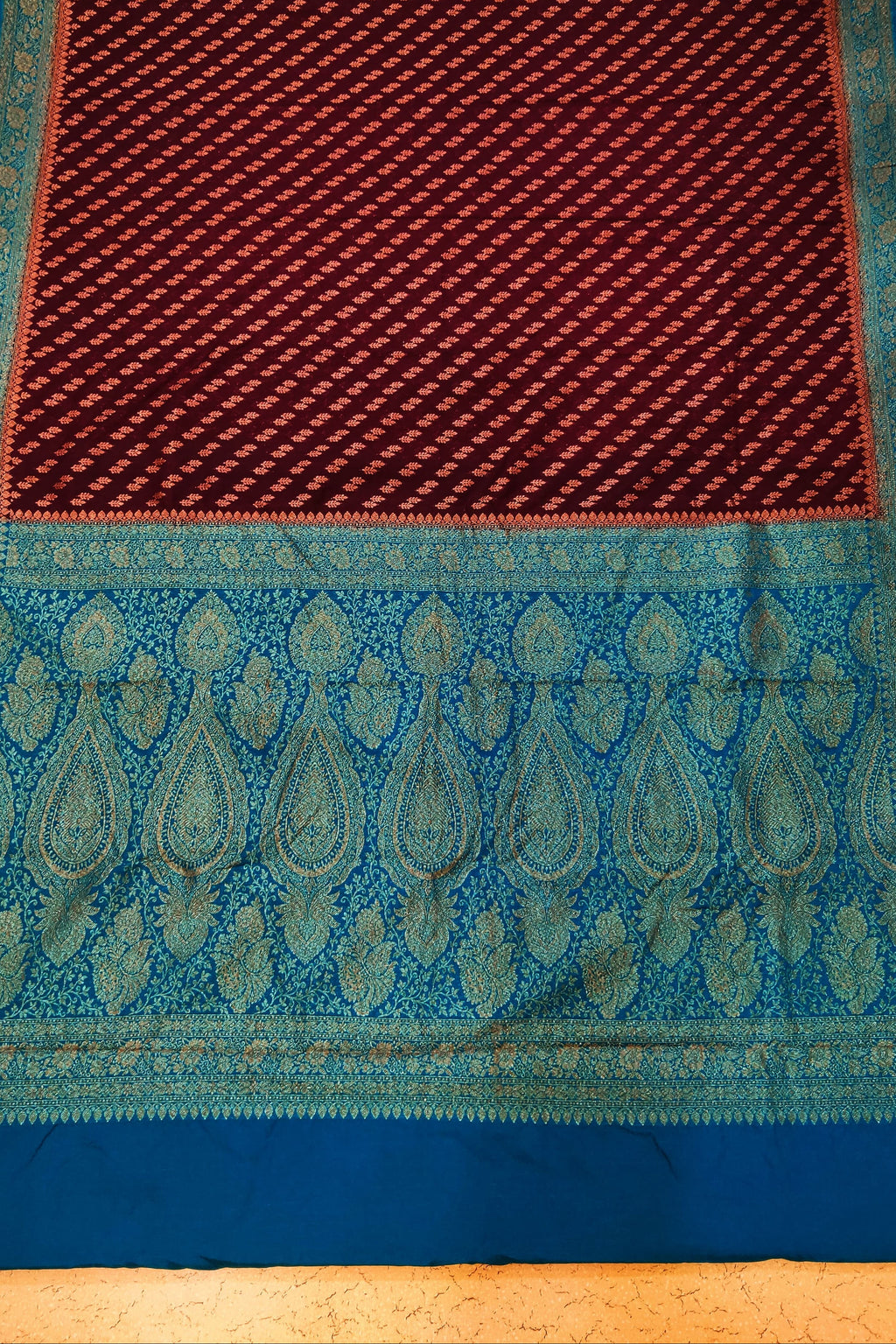 Blue and red patterned fabric on a wooden surface