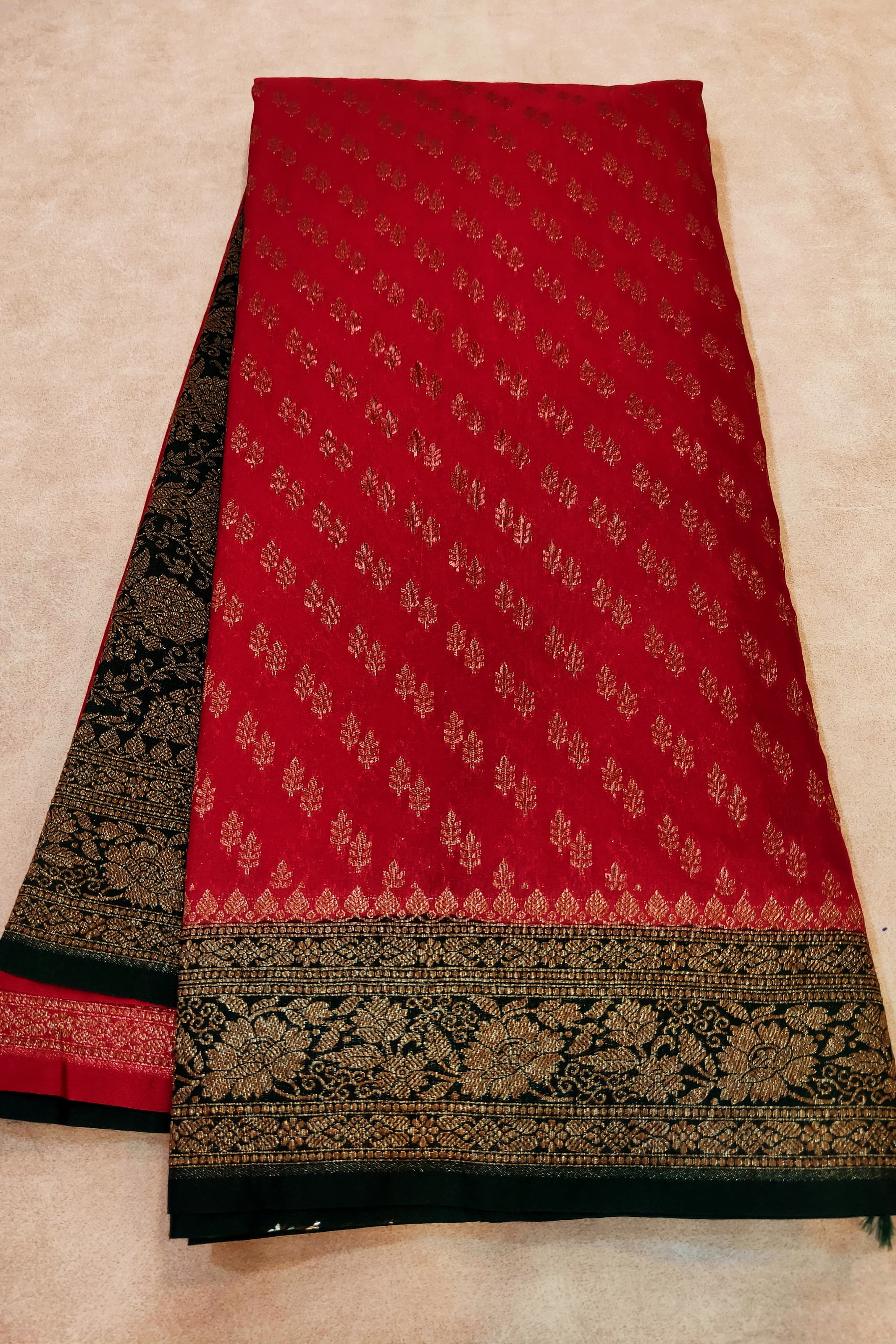 Red and black patterned fabric on a beige background