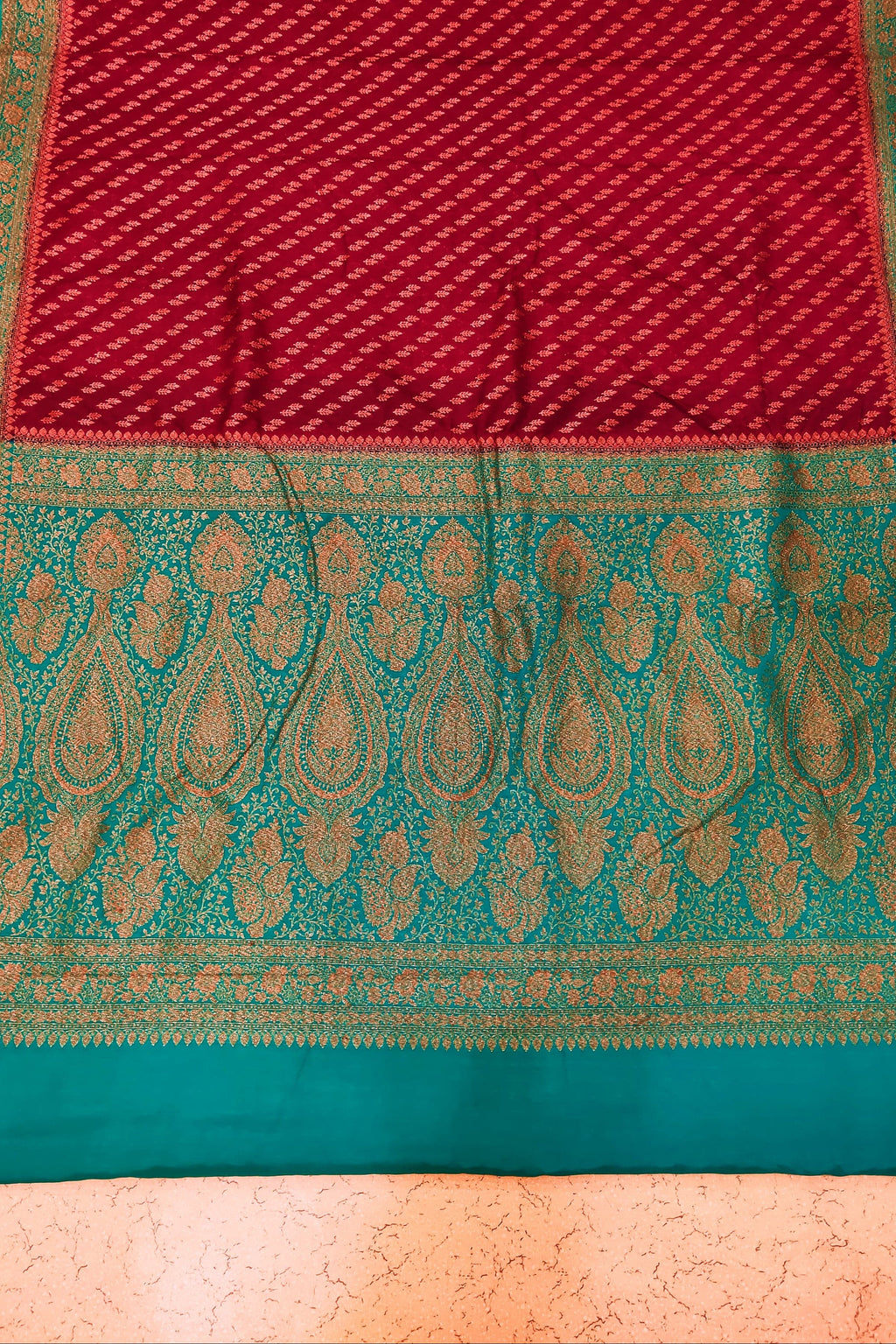 Saree with red and green pattern on a textured background