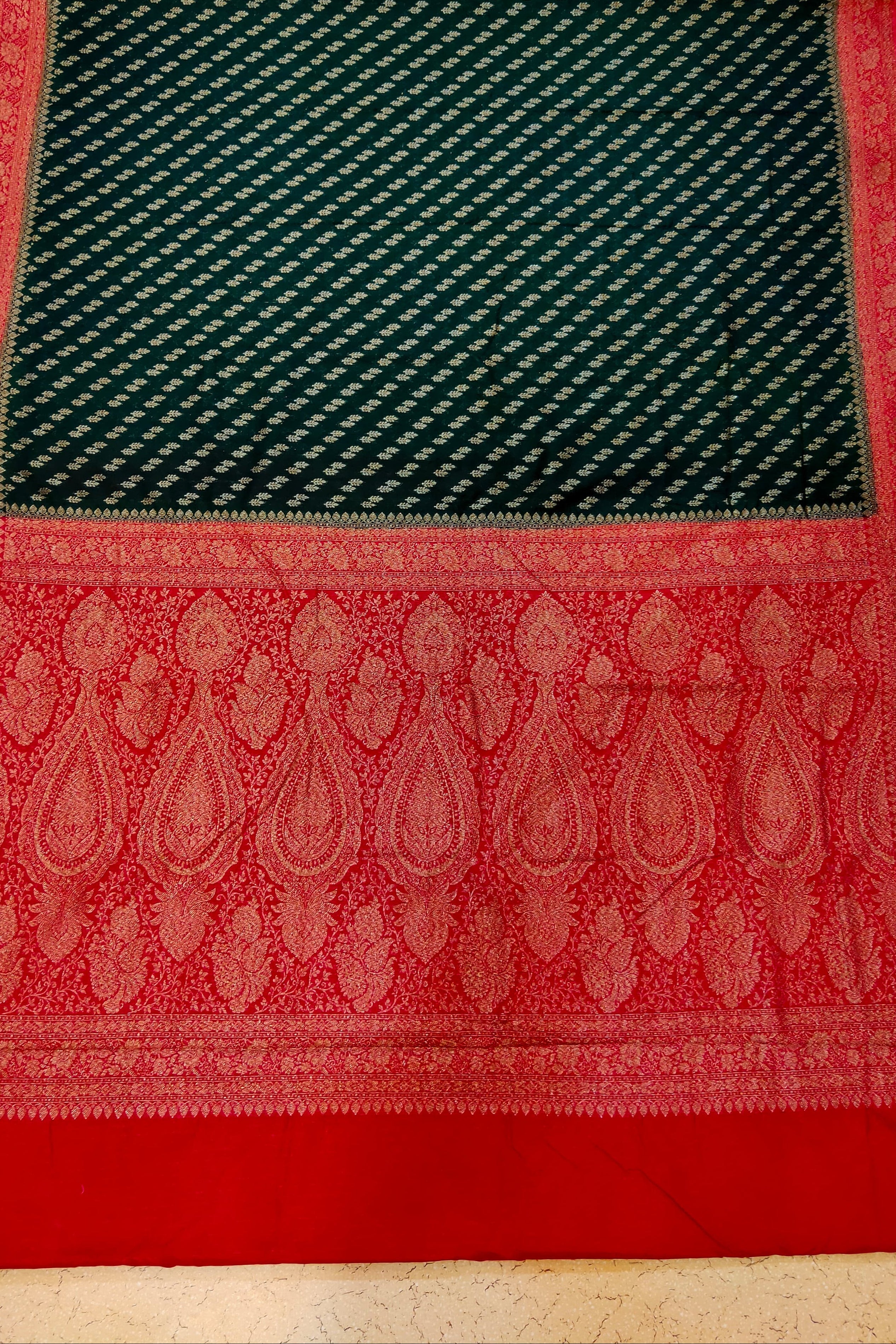 Red and green patterned fabric on a textured surface