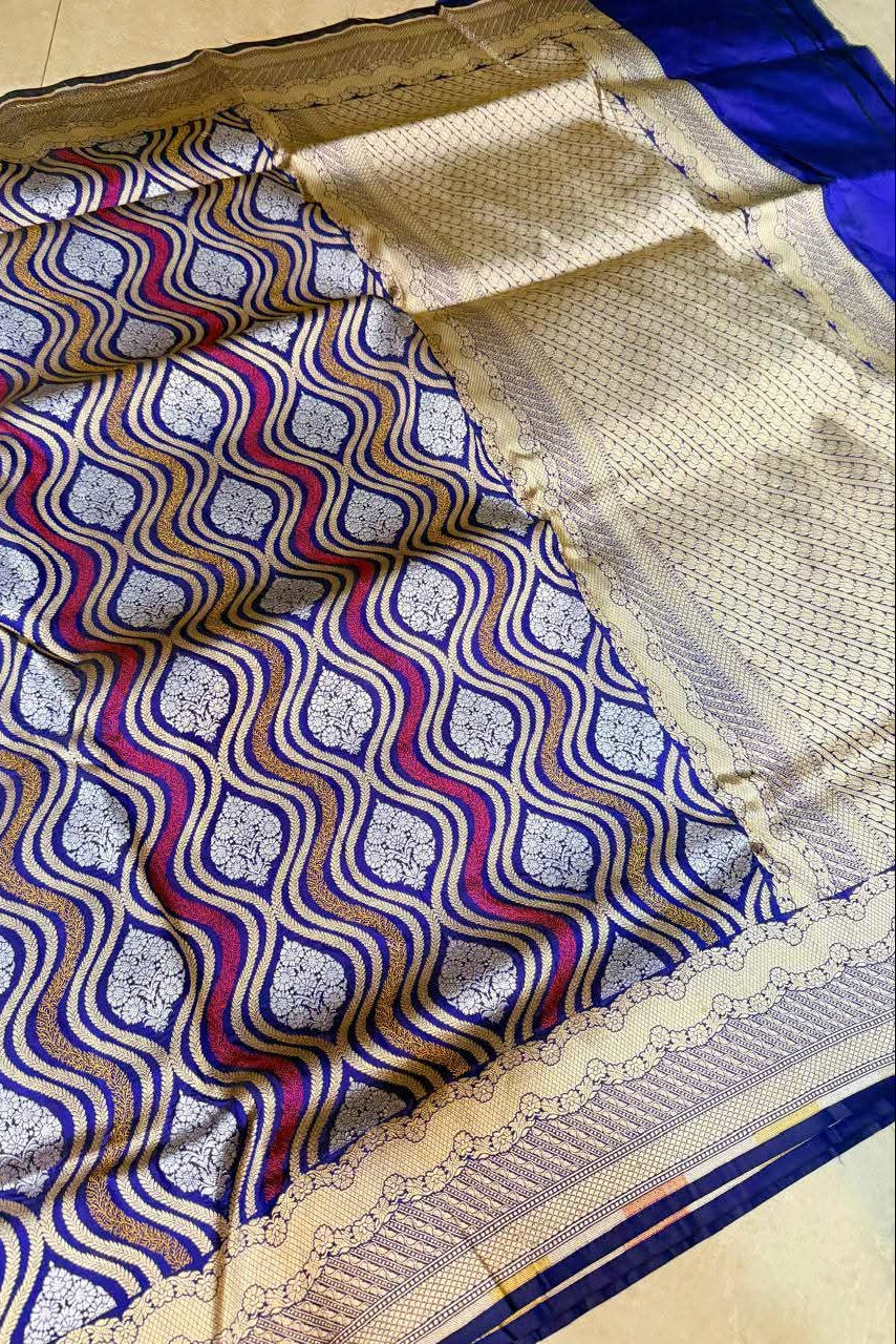 Saree with blue, red, and white pattern on a beige background