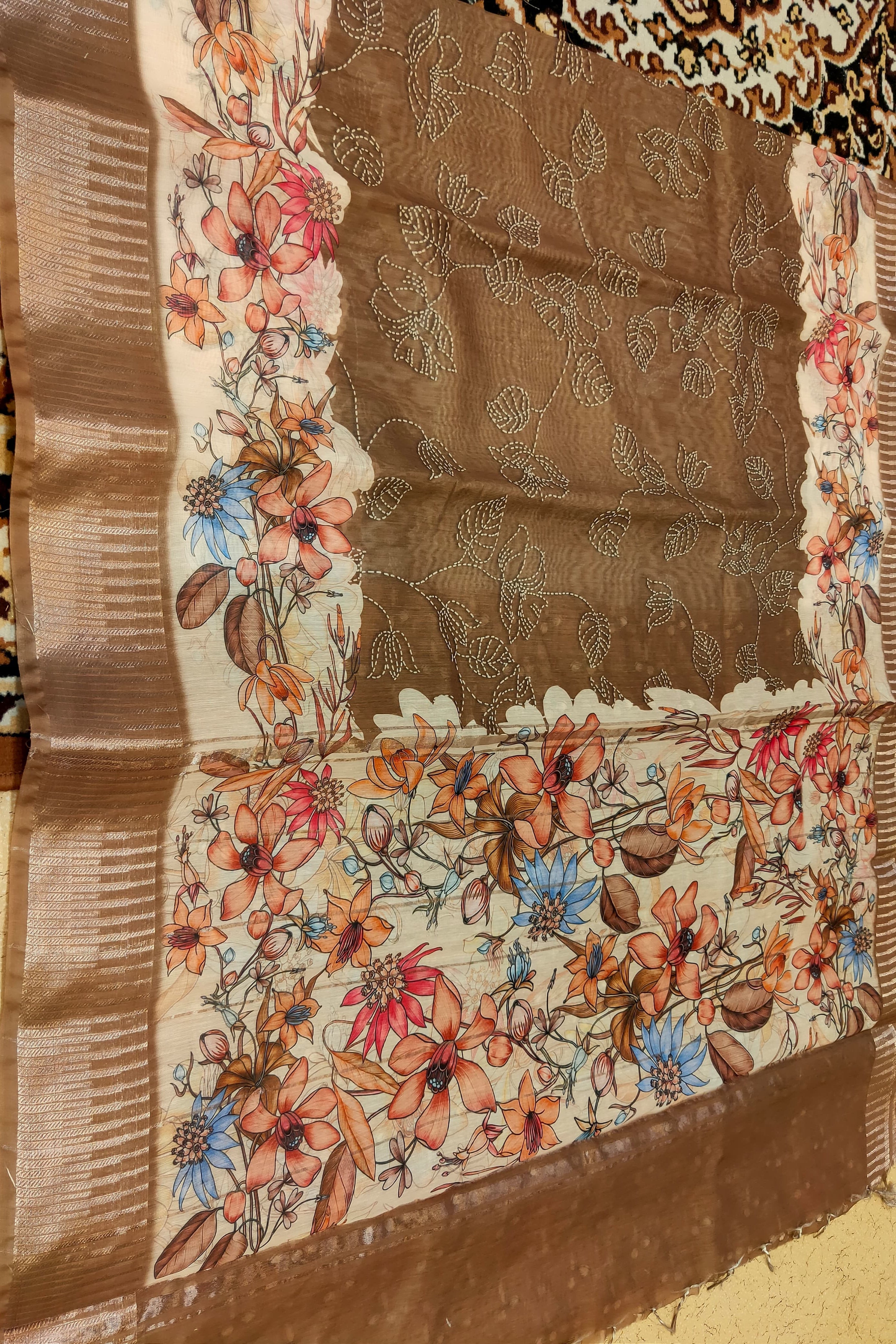 Close-up of a fabric with floral embroidery and brown background