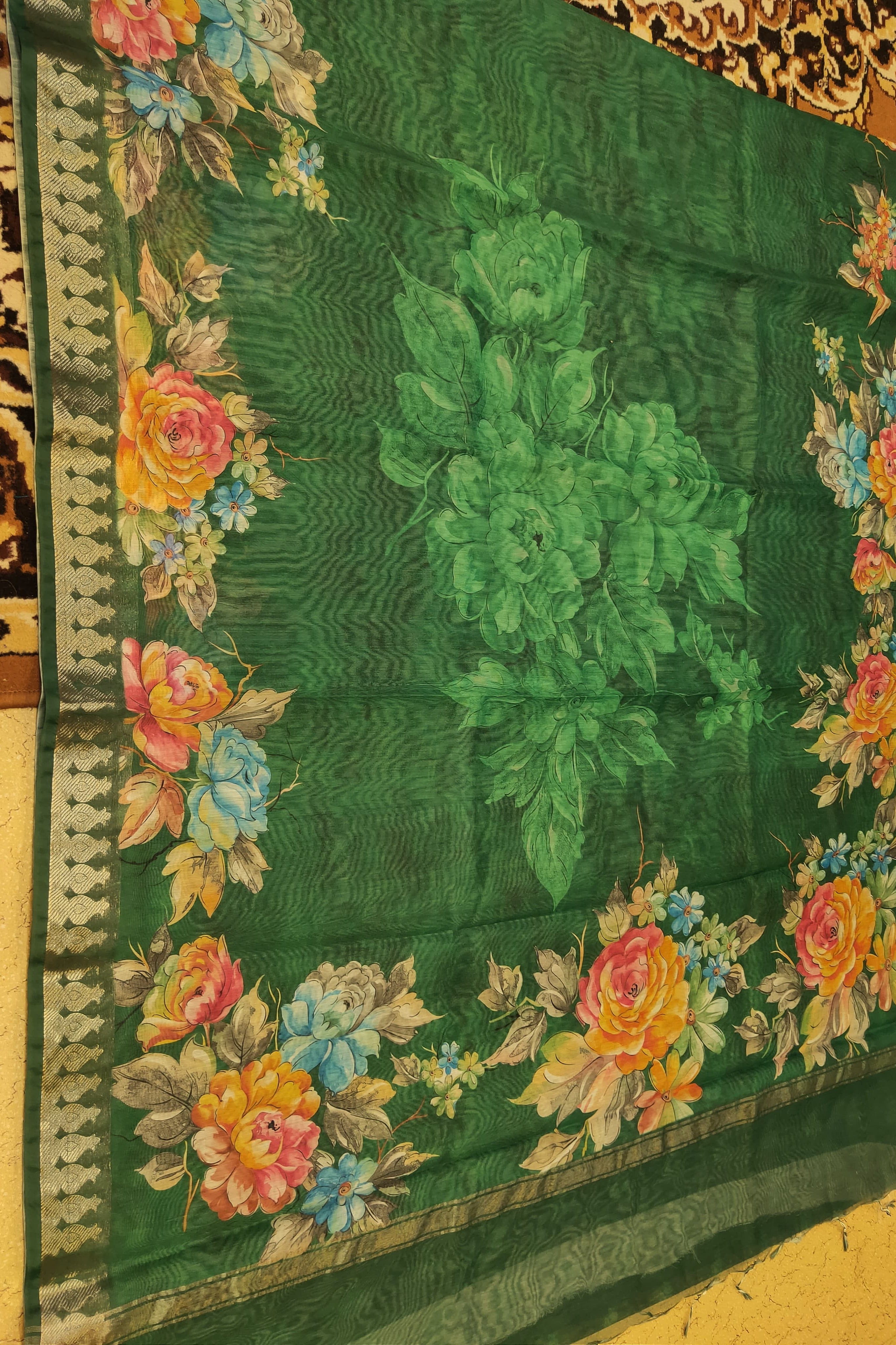 Green fabric with floral embroidery on a yellow background