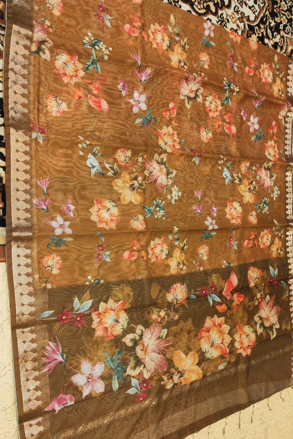 Floral patterned fabric on a brown background