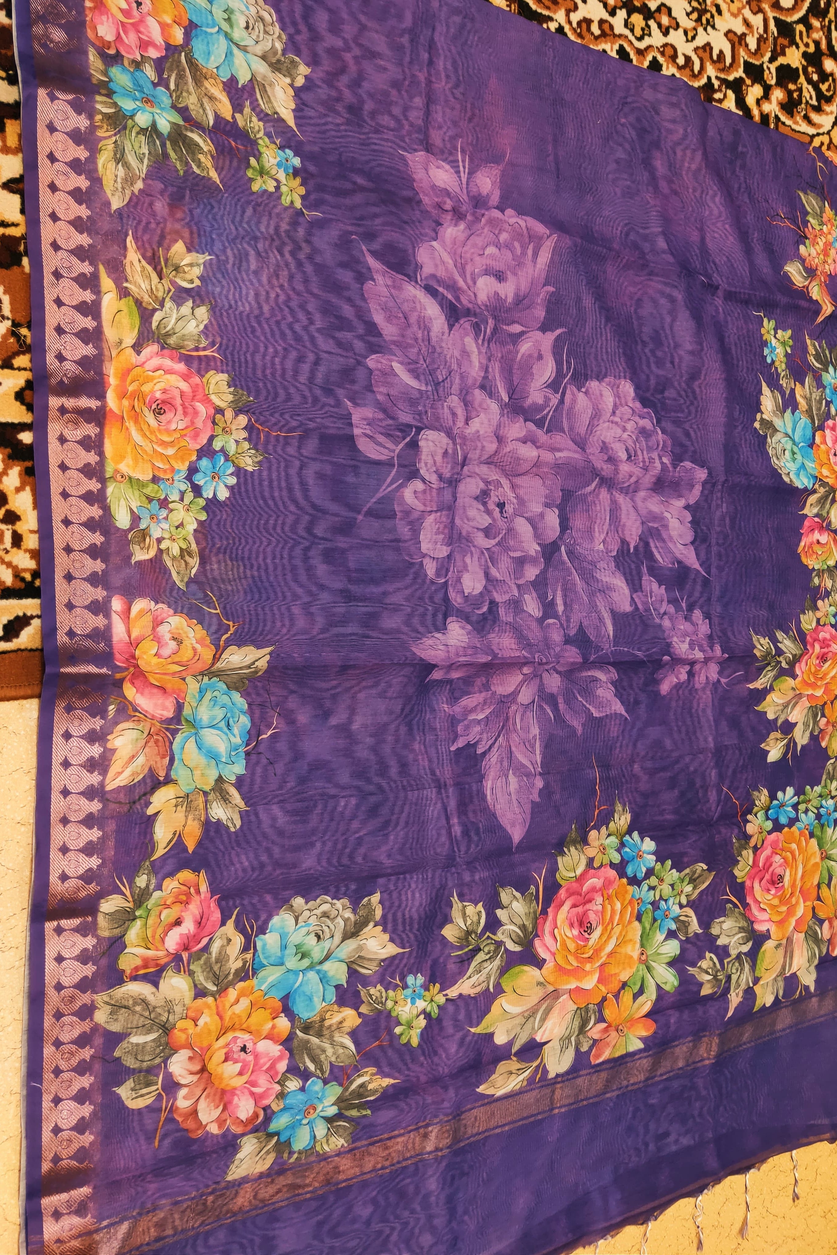 Floral patterned fabric with colorful flowers on a purple background