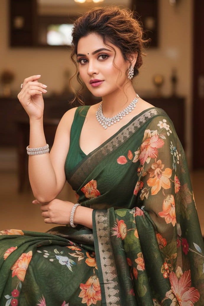 Woman in a green floral saree with jewelry indoors