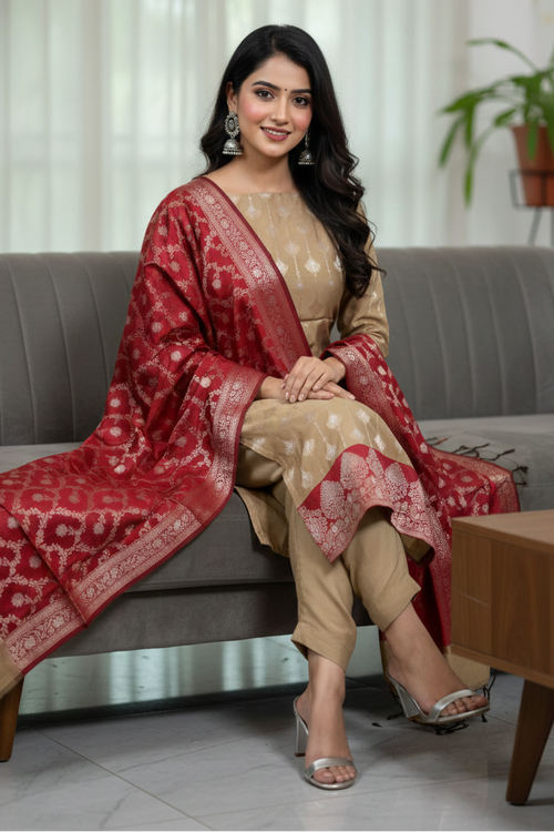 Woman in traditional attire sitting on a couch in a living room setting