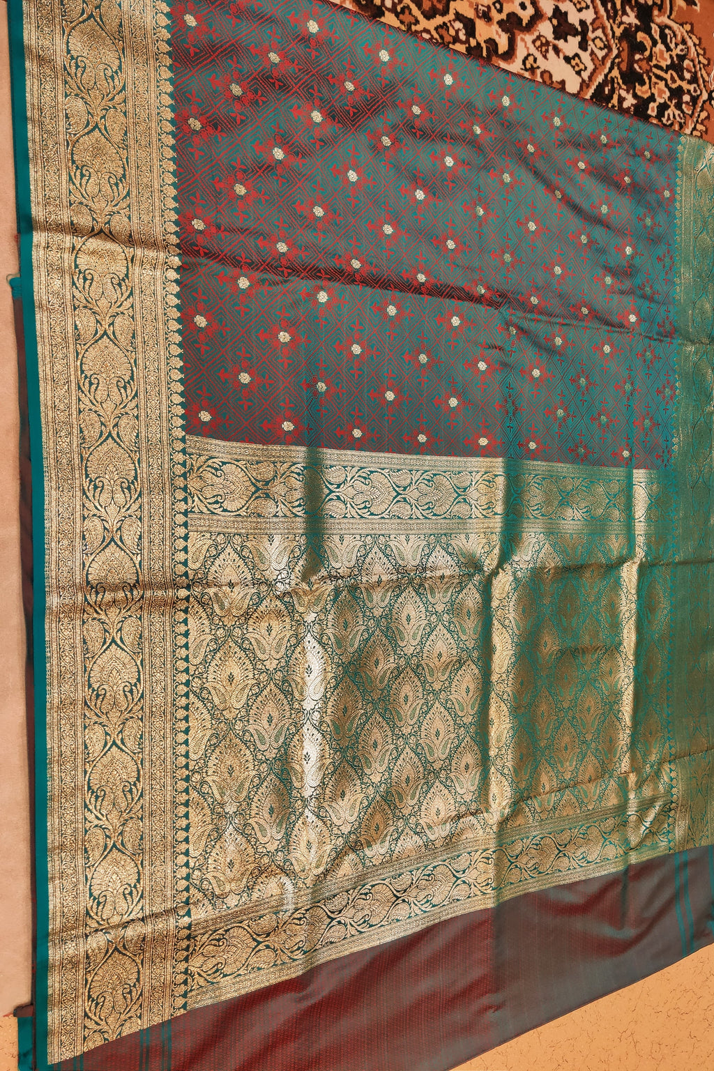 Traditional saree with intricate patterns on a plain background