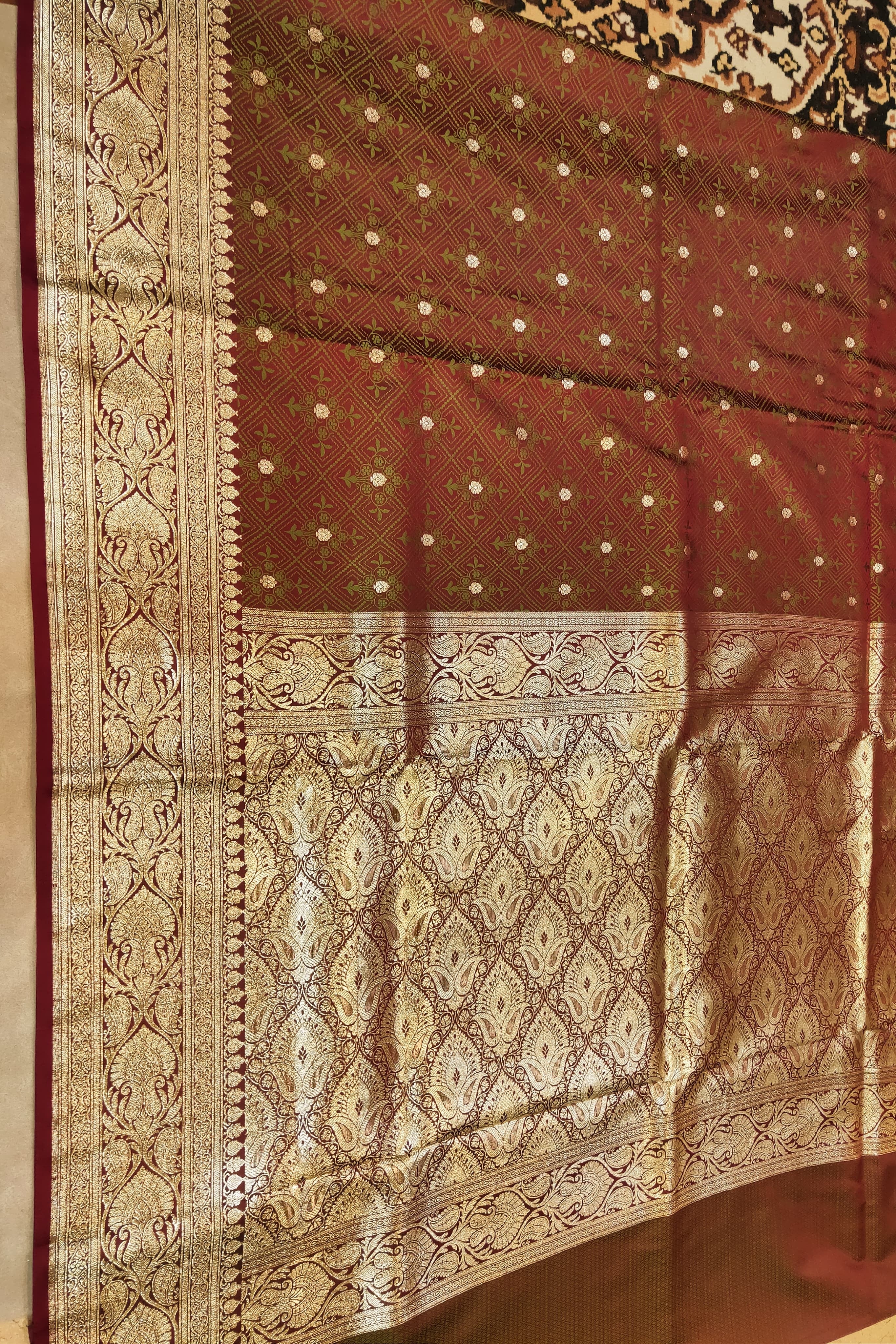 Brown and gold patterned fabric with intricate designs