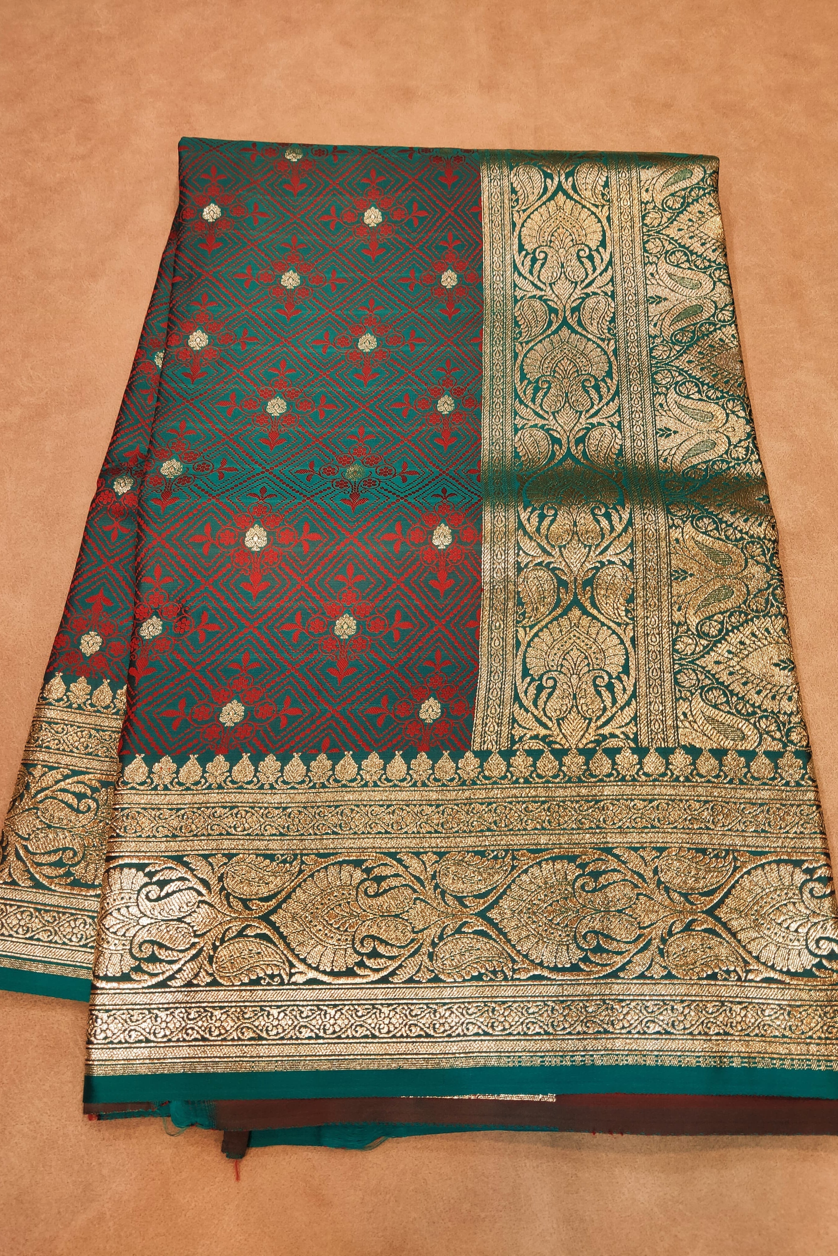 Traditional saree with intricate patterns on a beige background