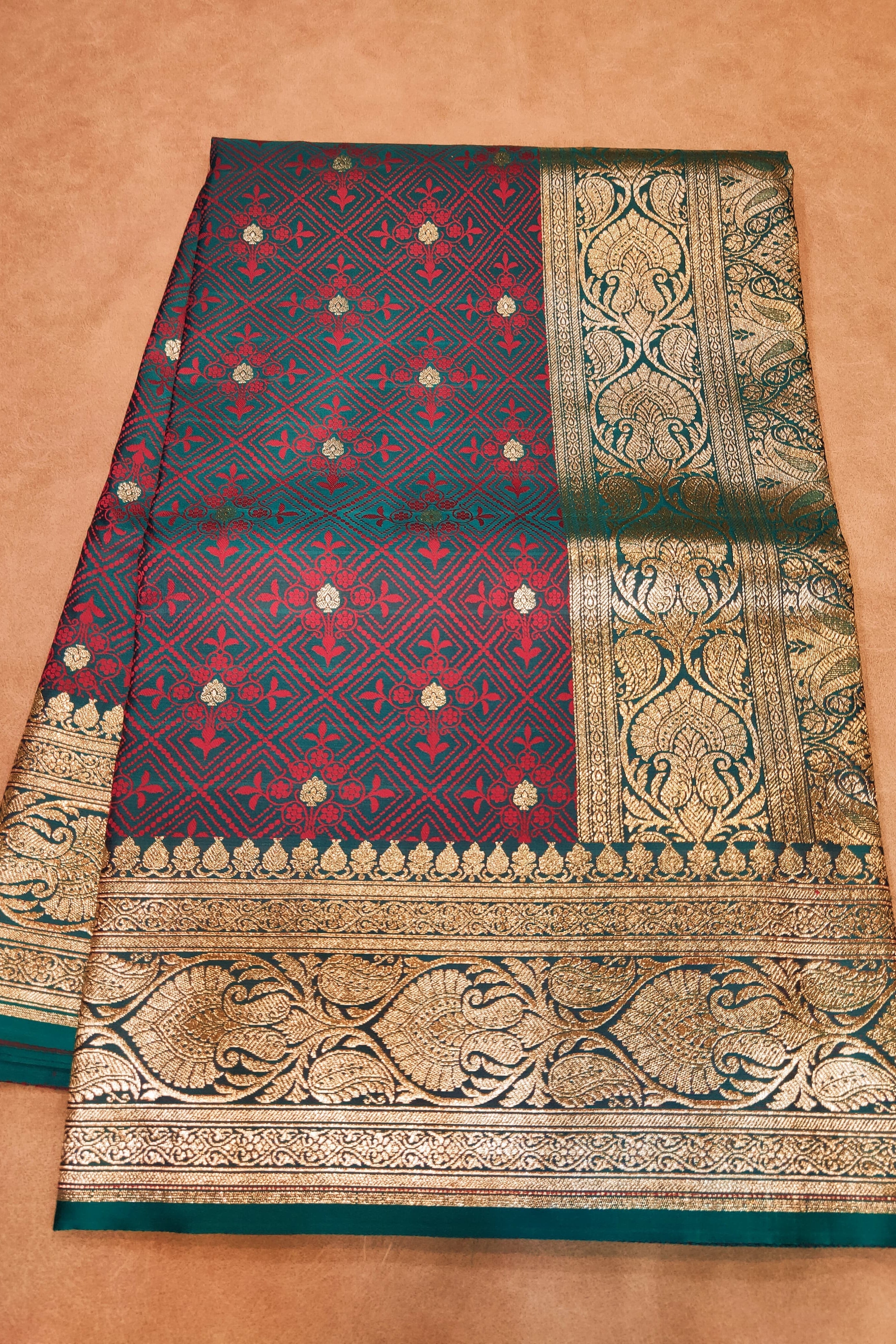Traditional saree with intricate patterns on a beige background