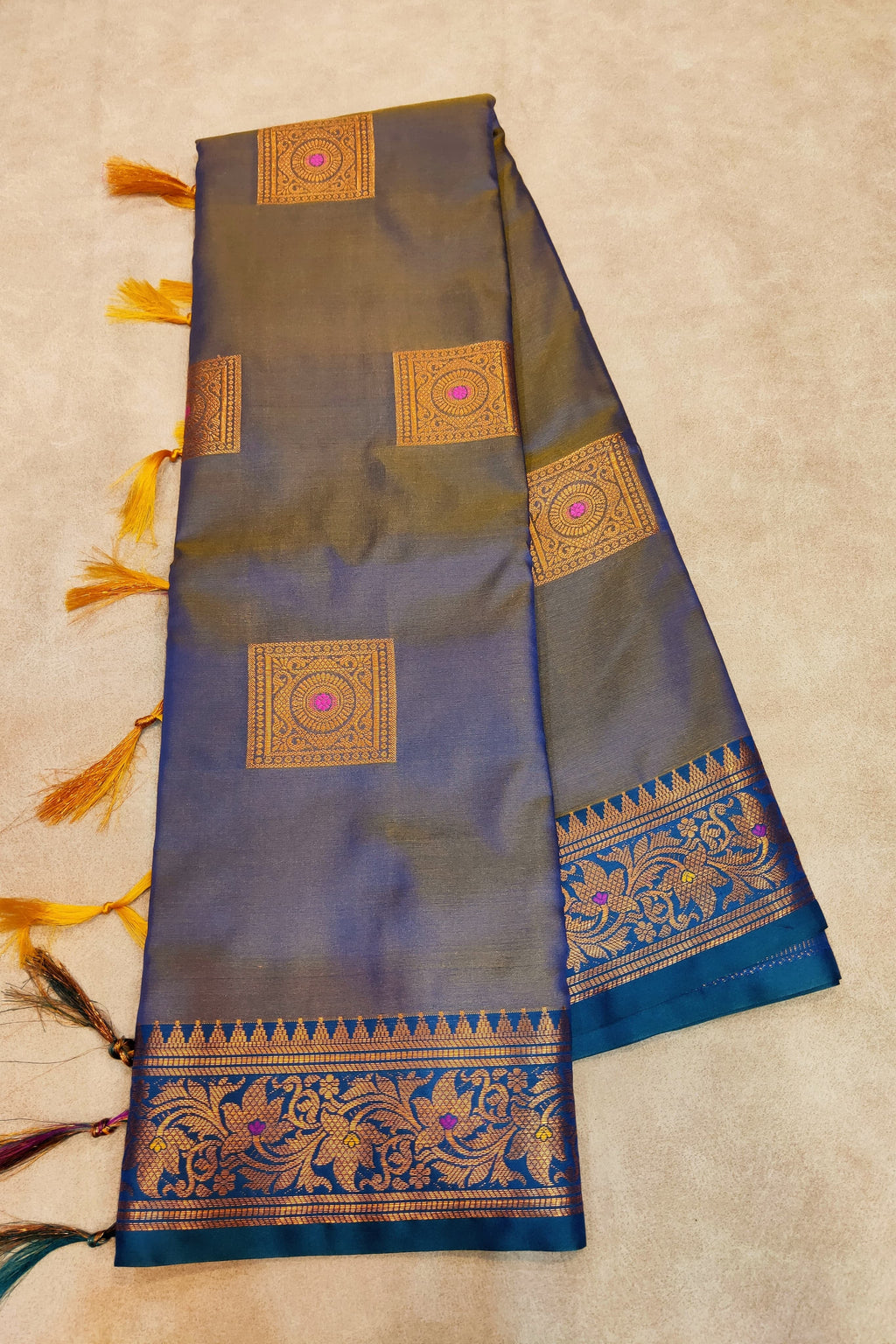 Decorative saree with intricate patterns on a beige background