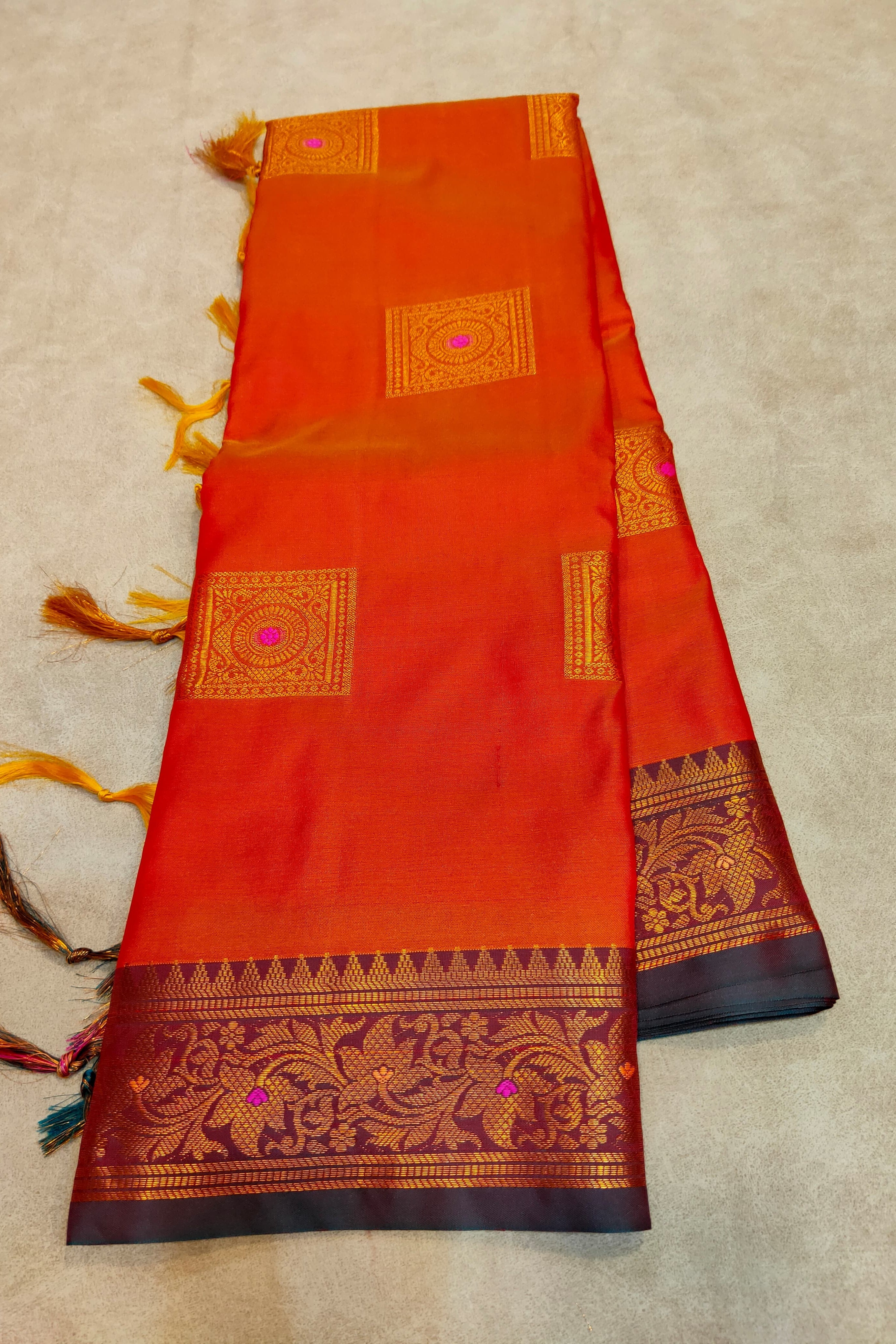 Traditional saree with intricate patterns on a beige background