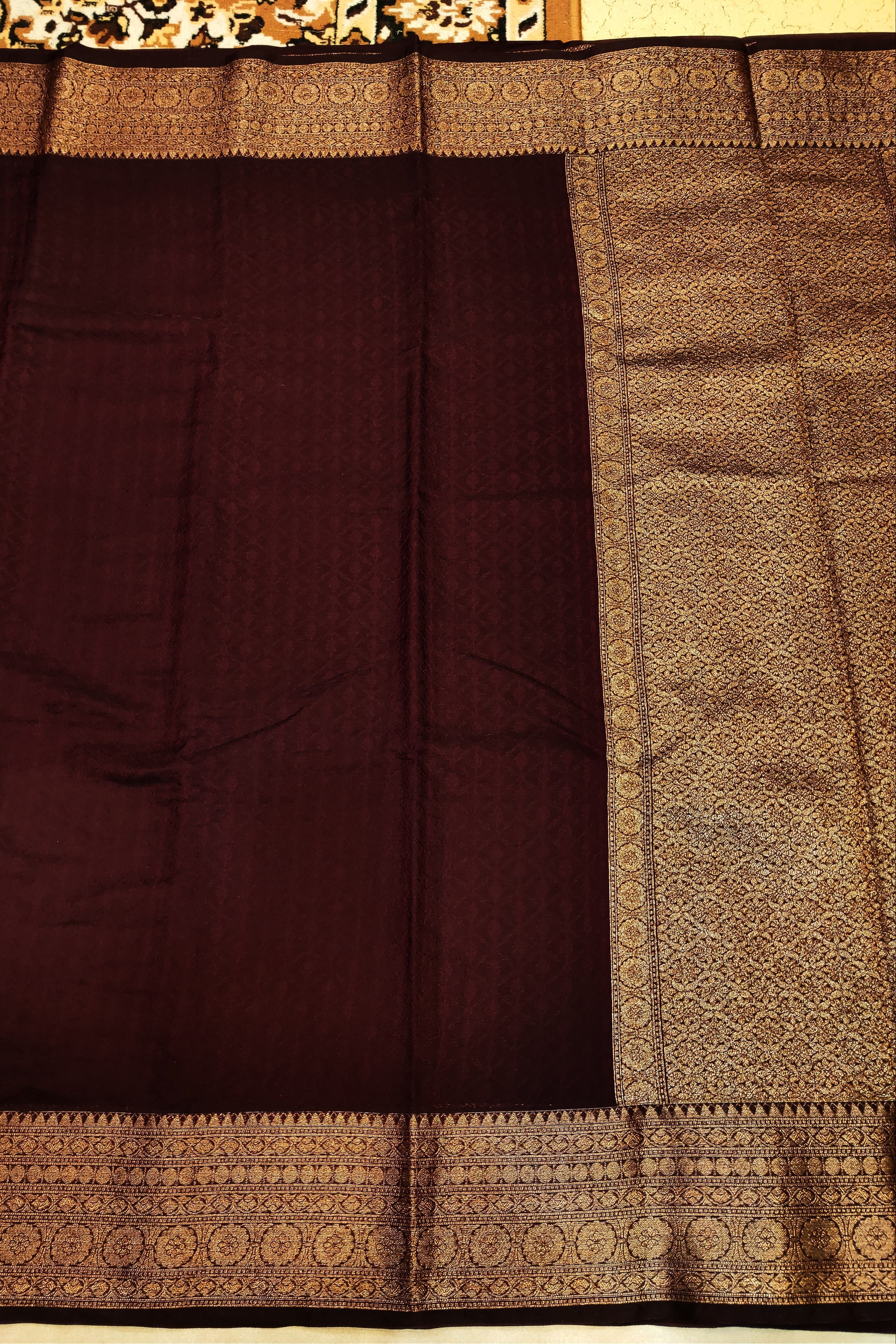 Brown saree with intricate gold border
