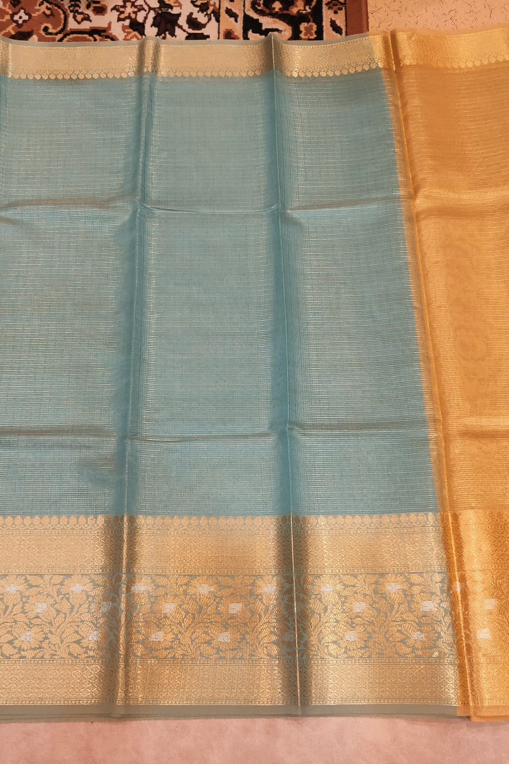 Saree with blue and gold pattern on a pink background