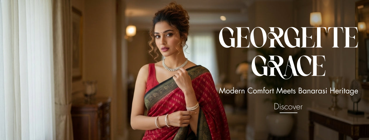 Woman in a red saree with 'Georgette Grace' branding in a blurred indoor setting