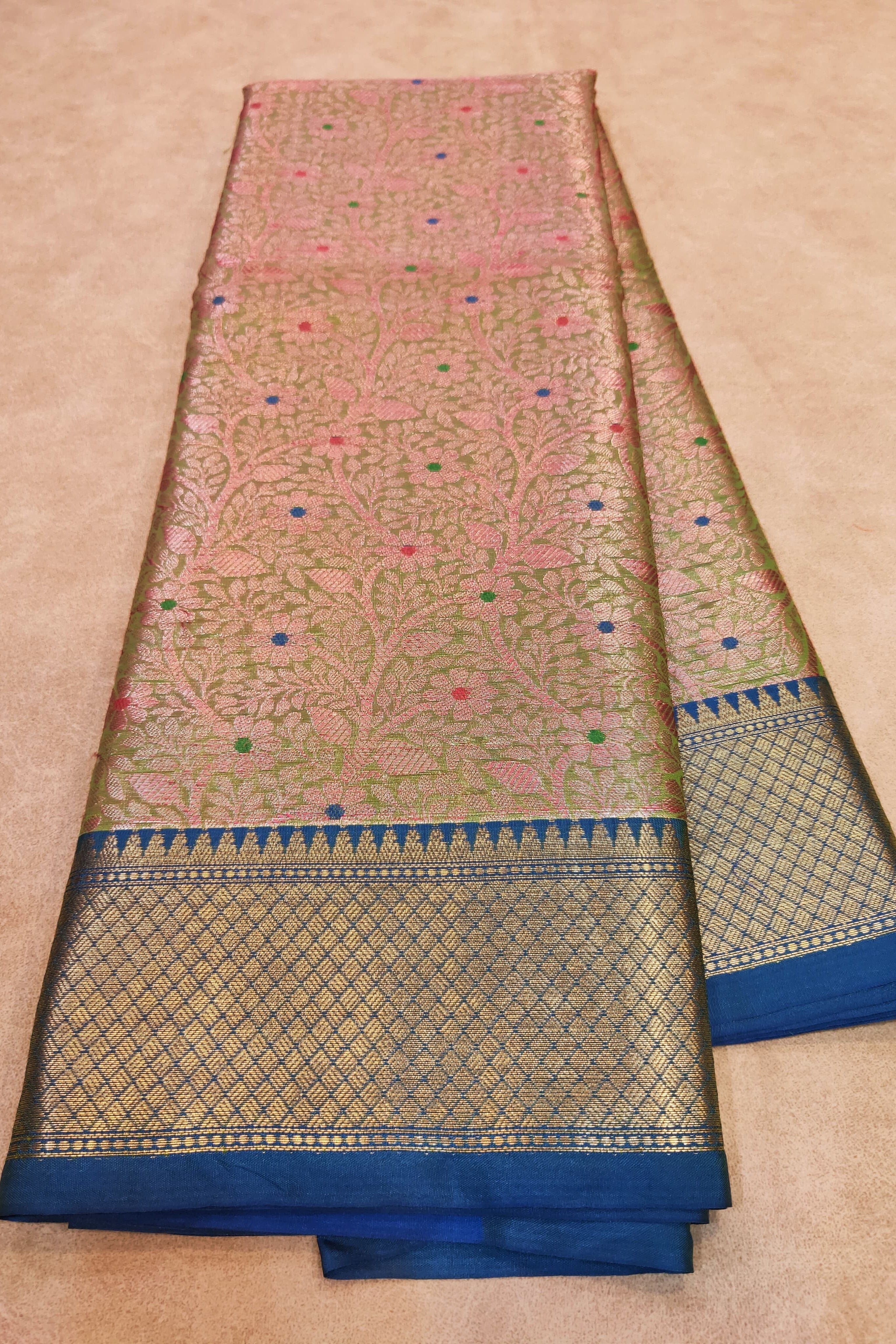 Traditional saree with intricate patterns on a beige background