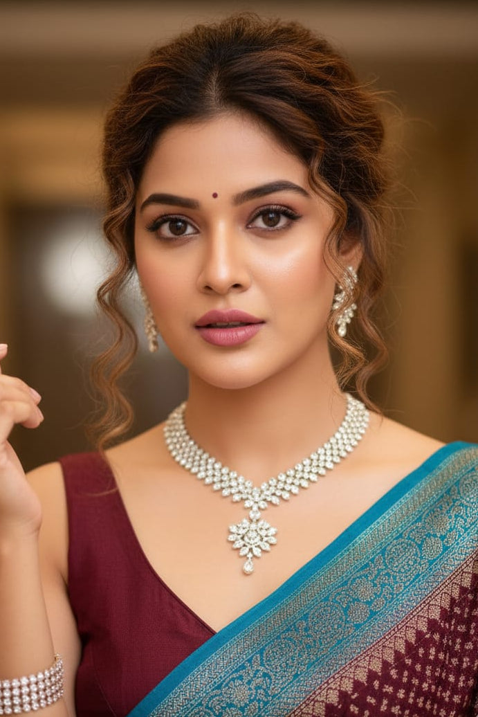 Woman wearing a traditional saree with jewelry in an indoor setting
