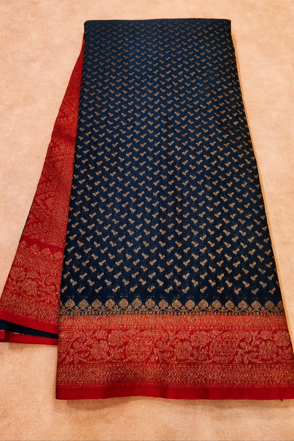 Navy blue and red patterned fabric on a beige background