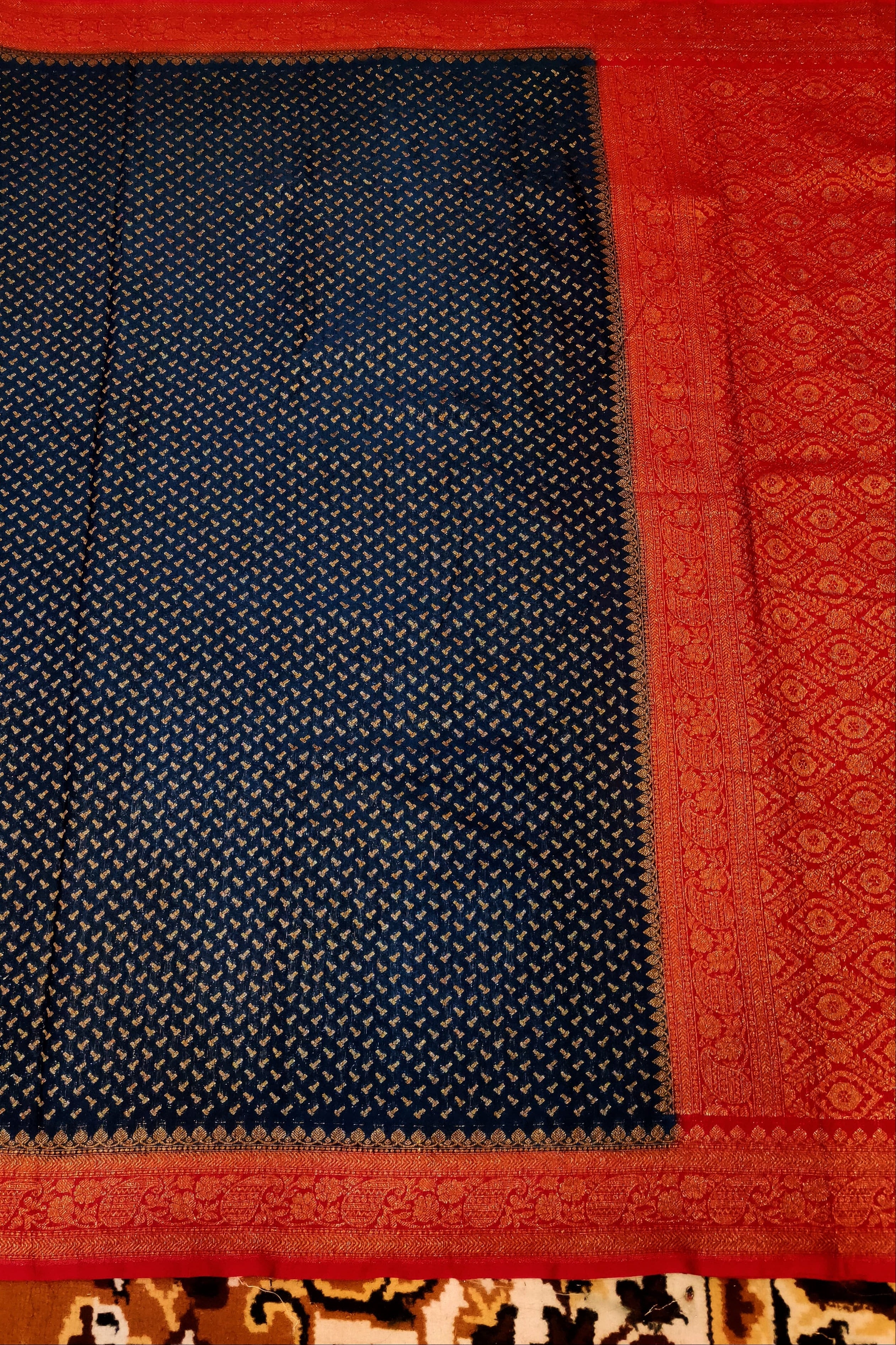 Black fabric with red border on a patterned background