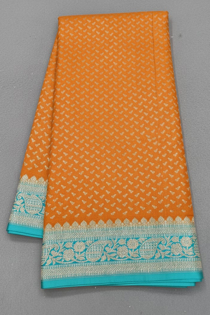Orange fabric with turquoise border on a gray background