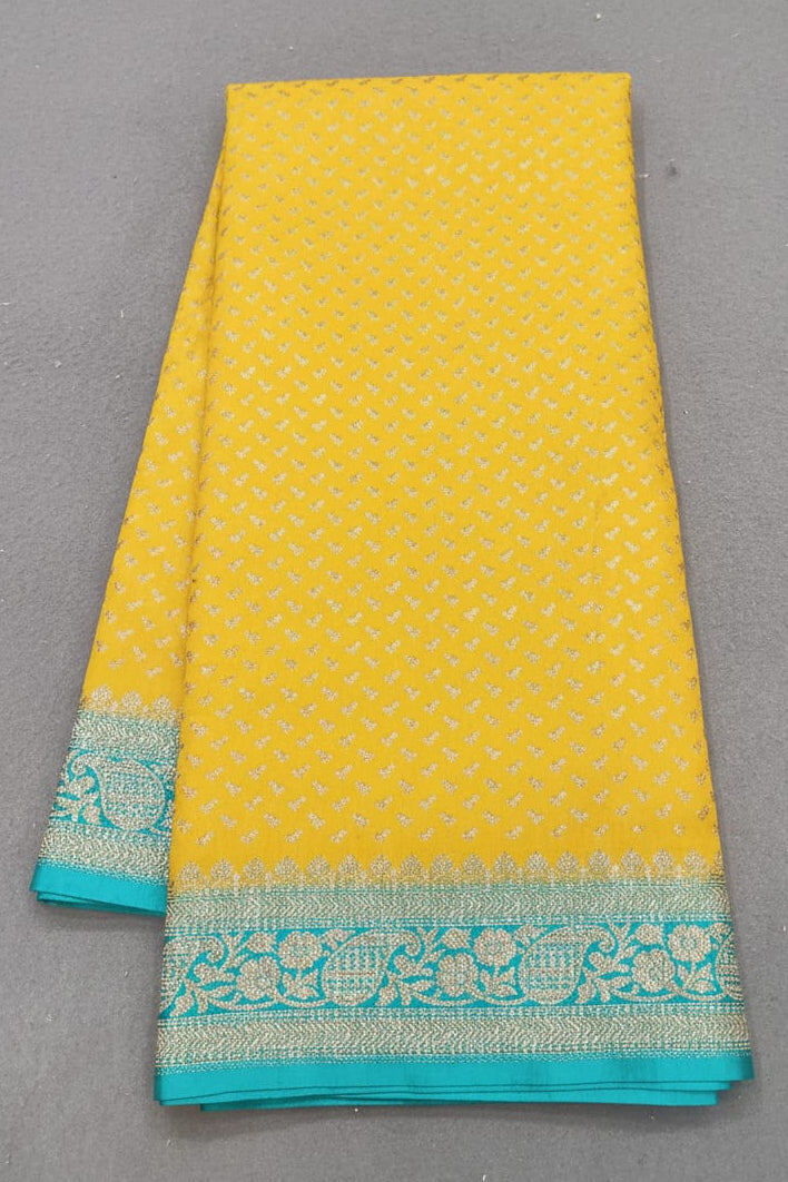 Yellow fabric with turquoise border on a gray background