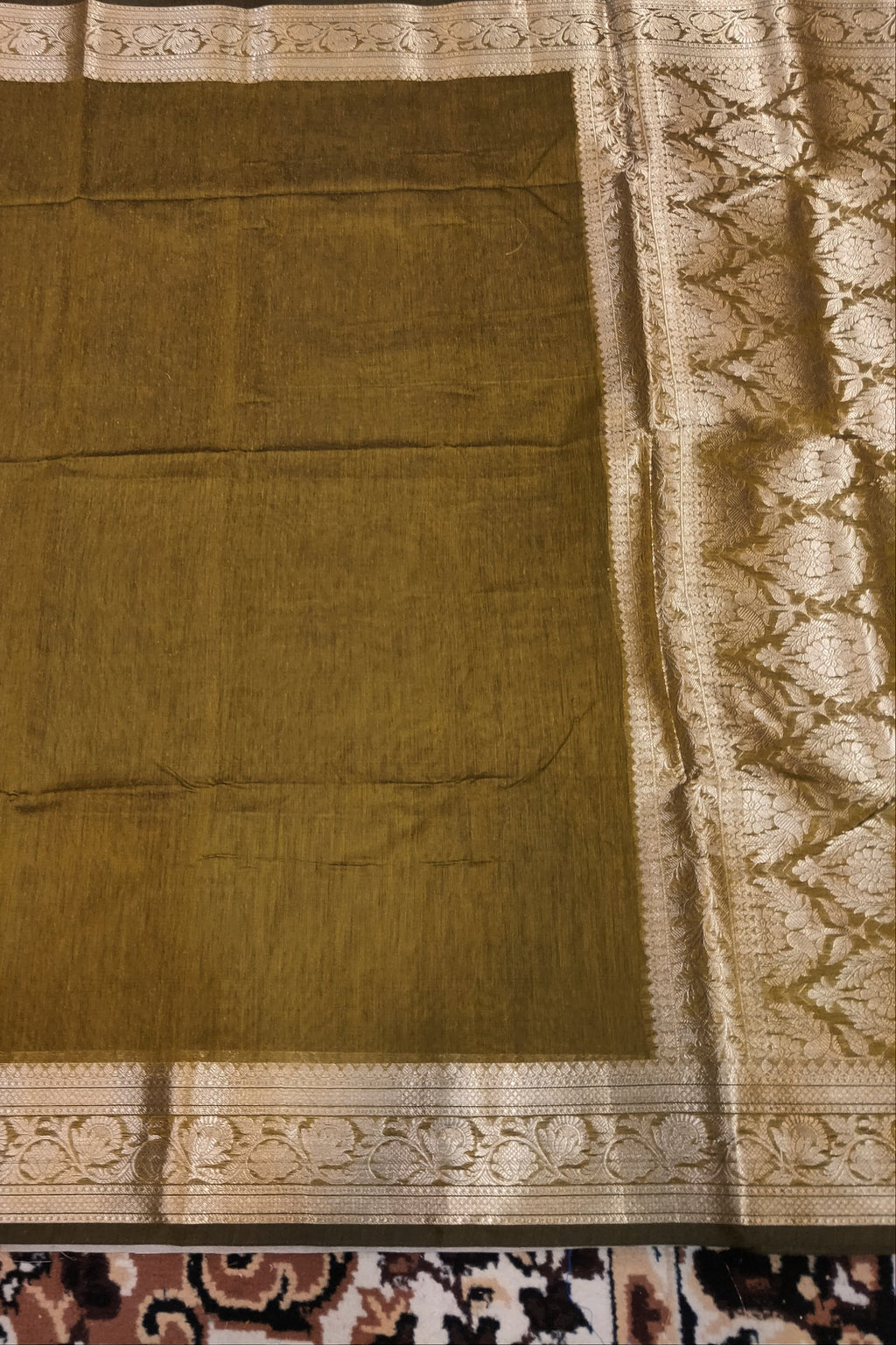 Brown fabric with intricate patterns on a patterned rug